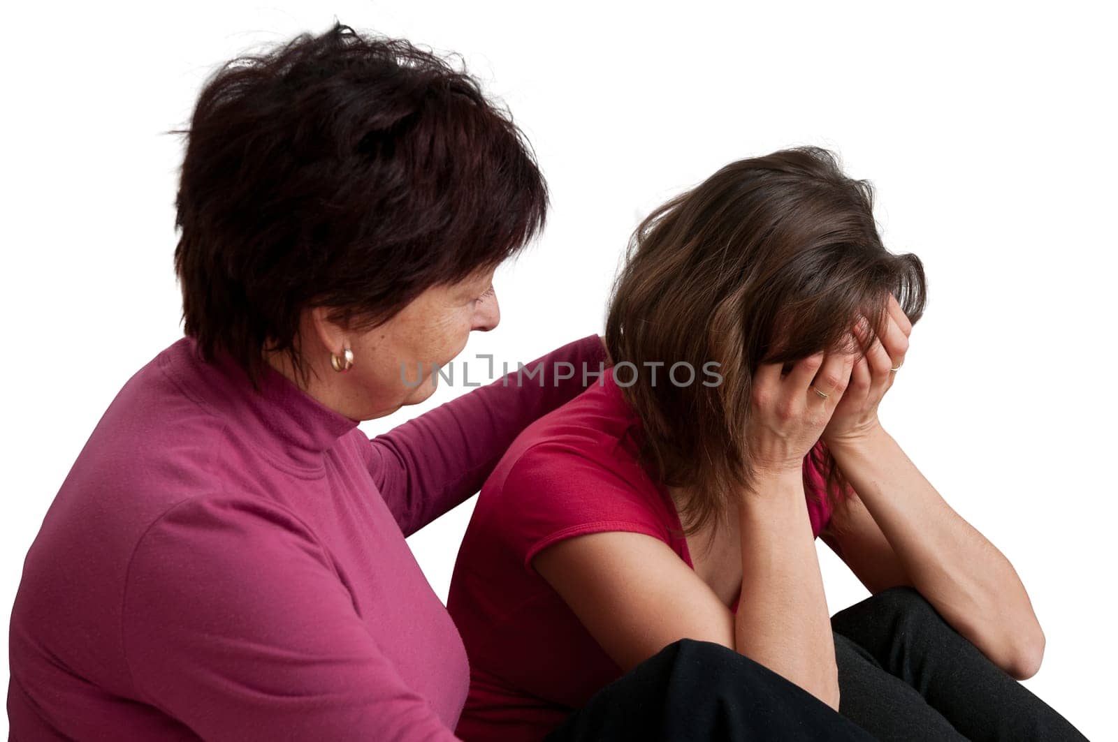 Mother (senior woman) comforts her worried aduld daughter - isolated on white