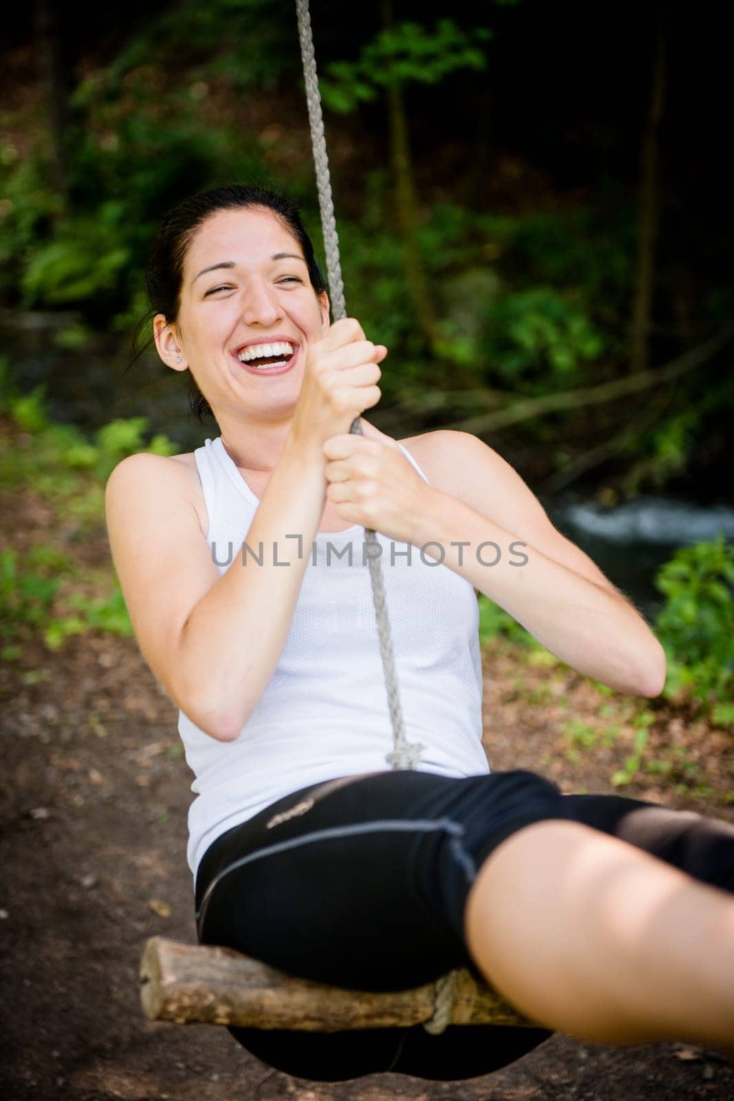 Young woman swinging on seesaw outdoor in nature