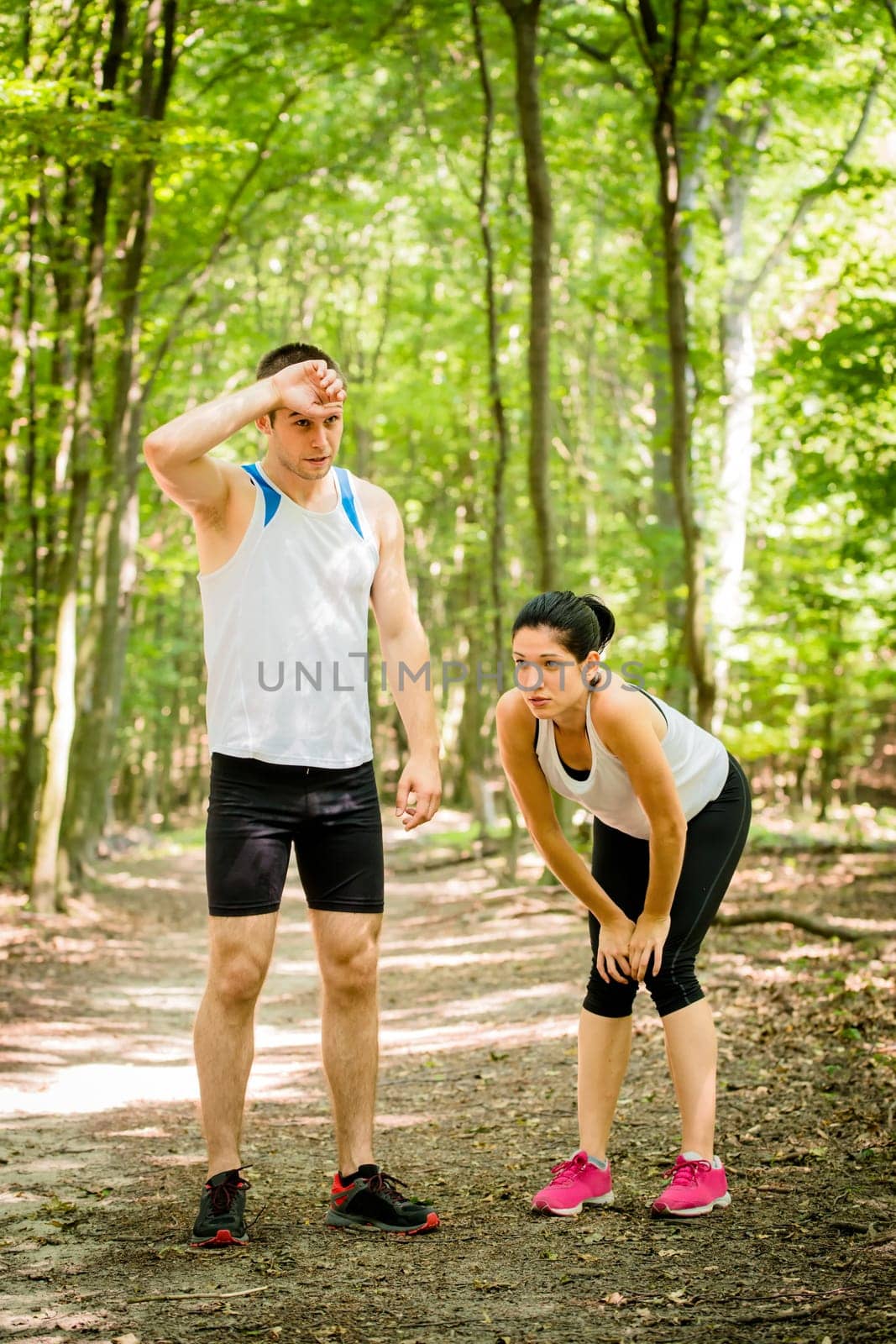Sport couple very tired after sporting relaxing in nature (forest)