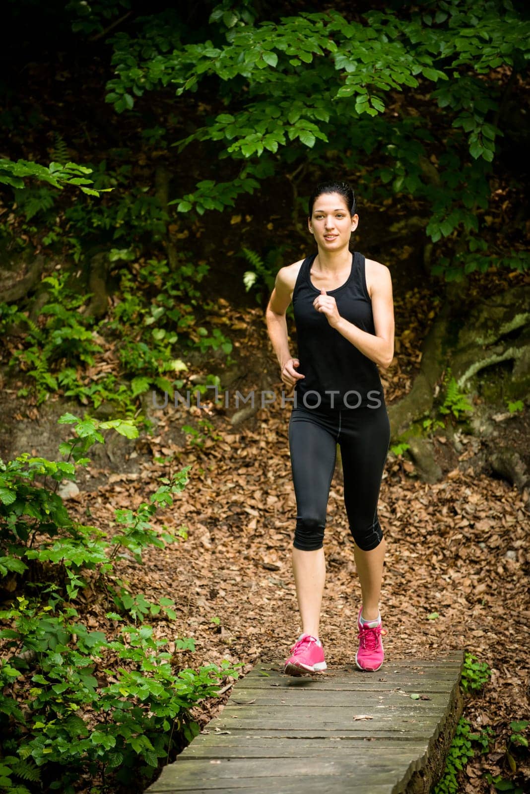 Running for health - young woman jogging in nature