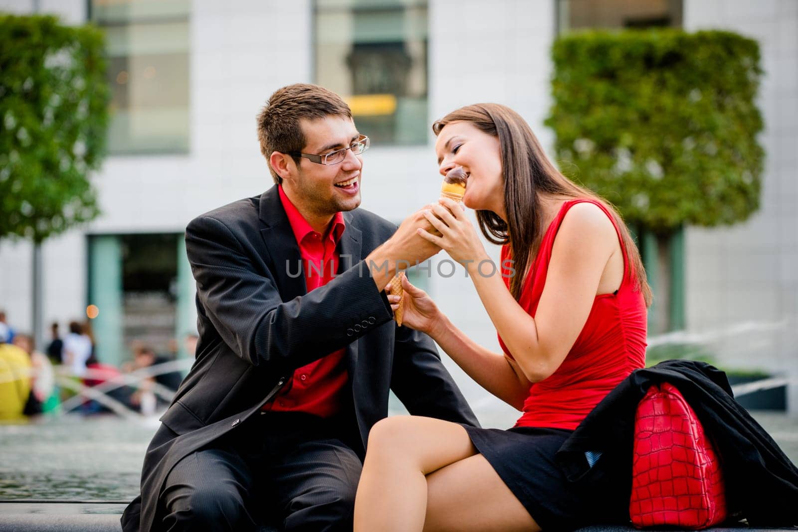 Sharing icecream - young business people having great time together outdoor
