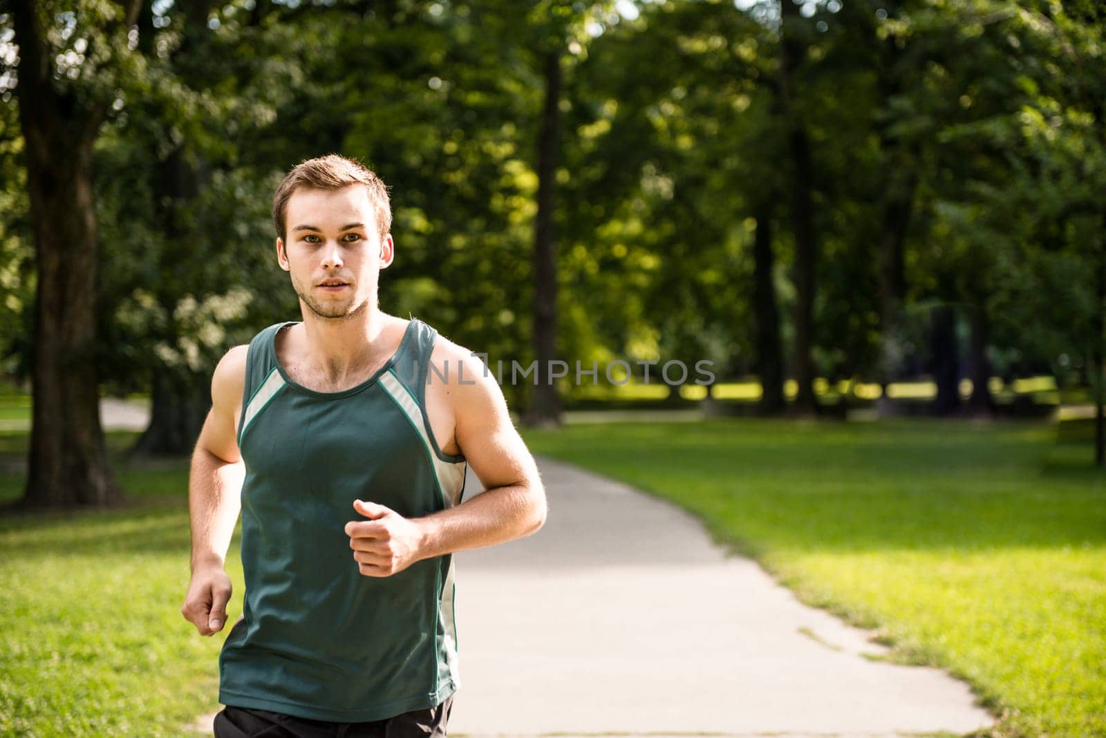 Jogging lifestyle - young attractive man running in park