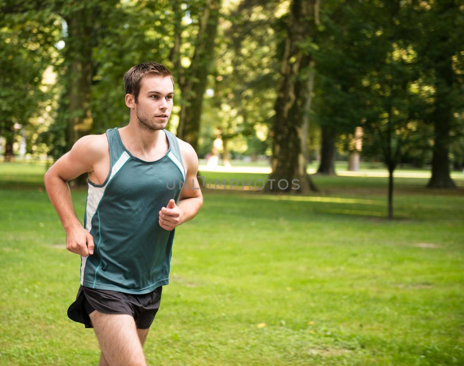 Jogging lifestyle - young attractive man running in park