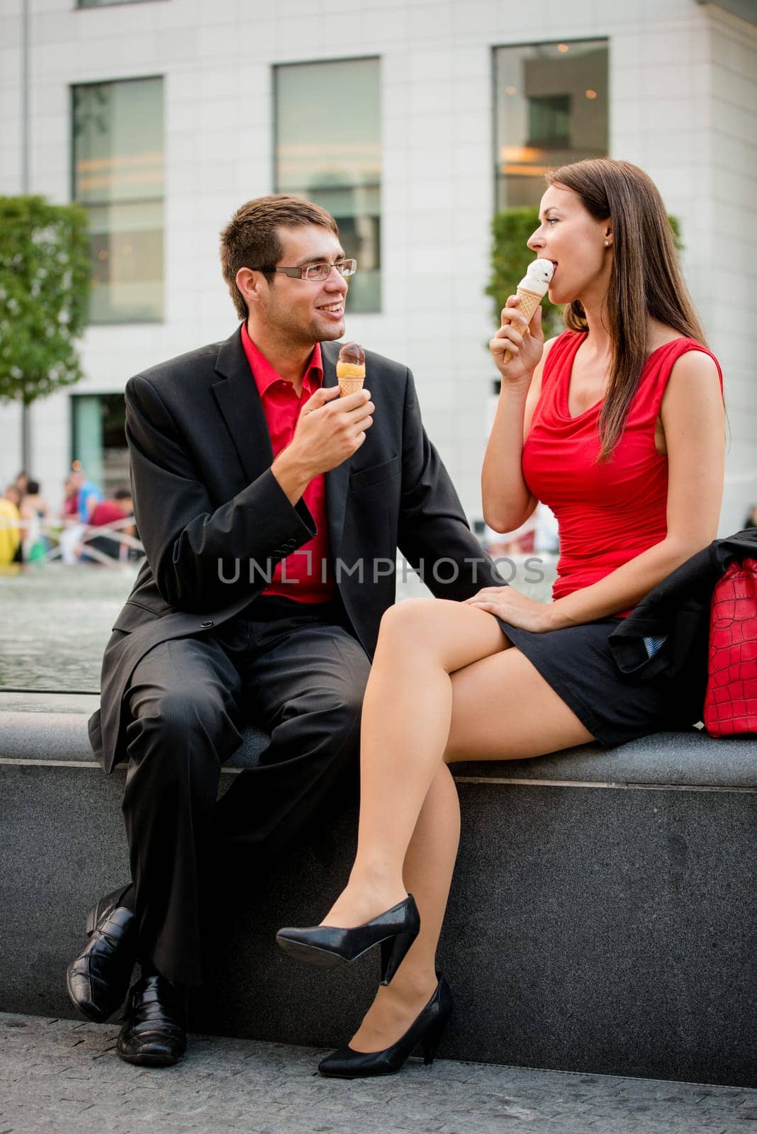 Together on icecream - young business people having great time in street