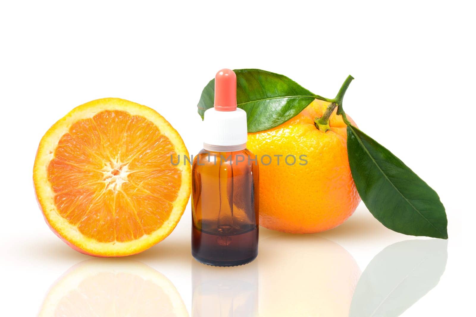 Orange with green leaves and a bottle with dropper isolated on a white background. Alternative medicine concept