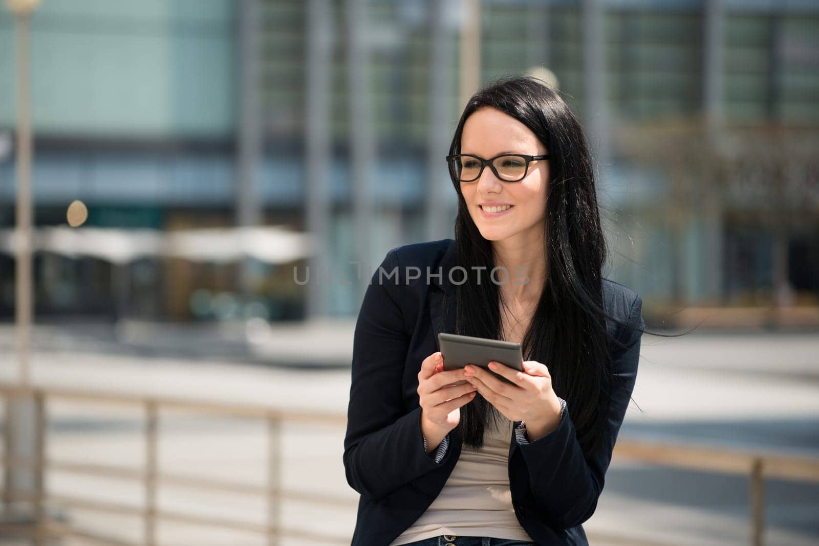 Young woman reading book on electronic book-reader