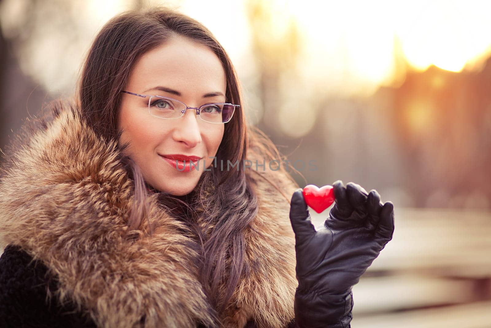 Pretty woman holding red heart on Valentines day