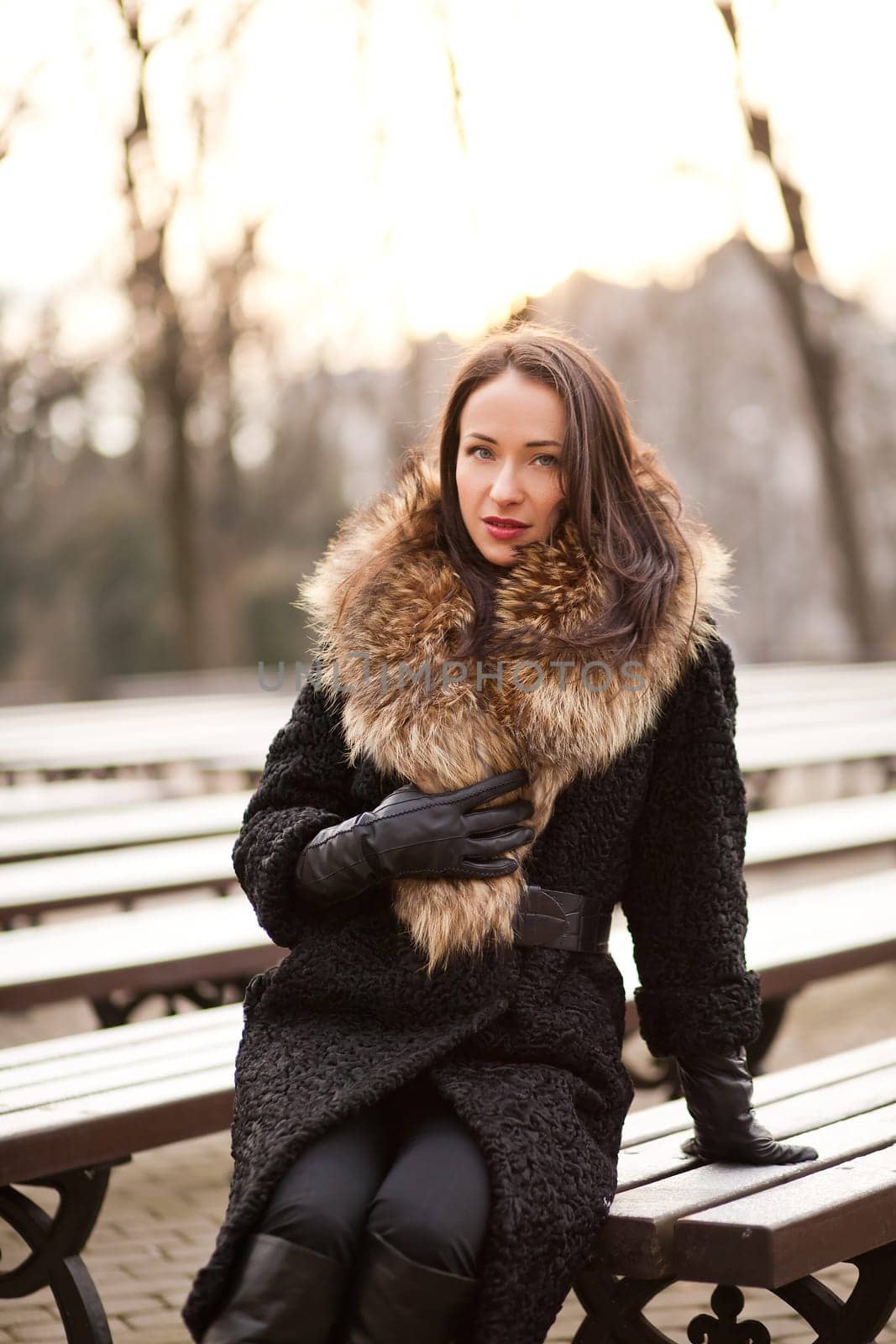 Young professional lady in the park is enjoying winter