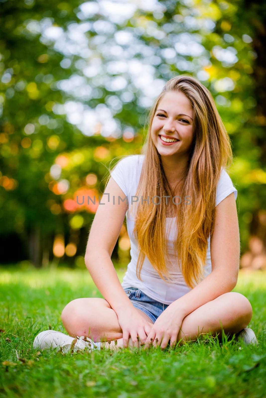 Portrait of young beautiful woman (teenage girl) - outside on grass