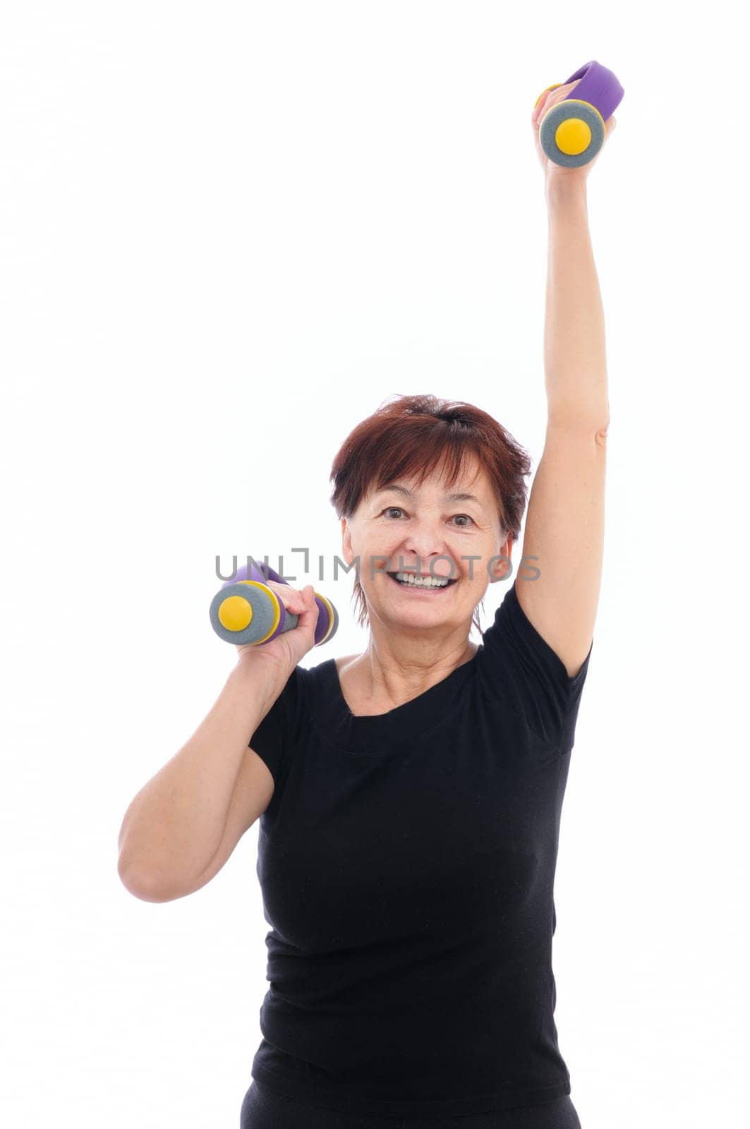 Smiling senior fitness woman with barbells