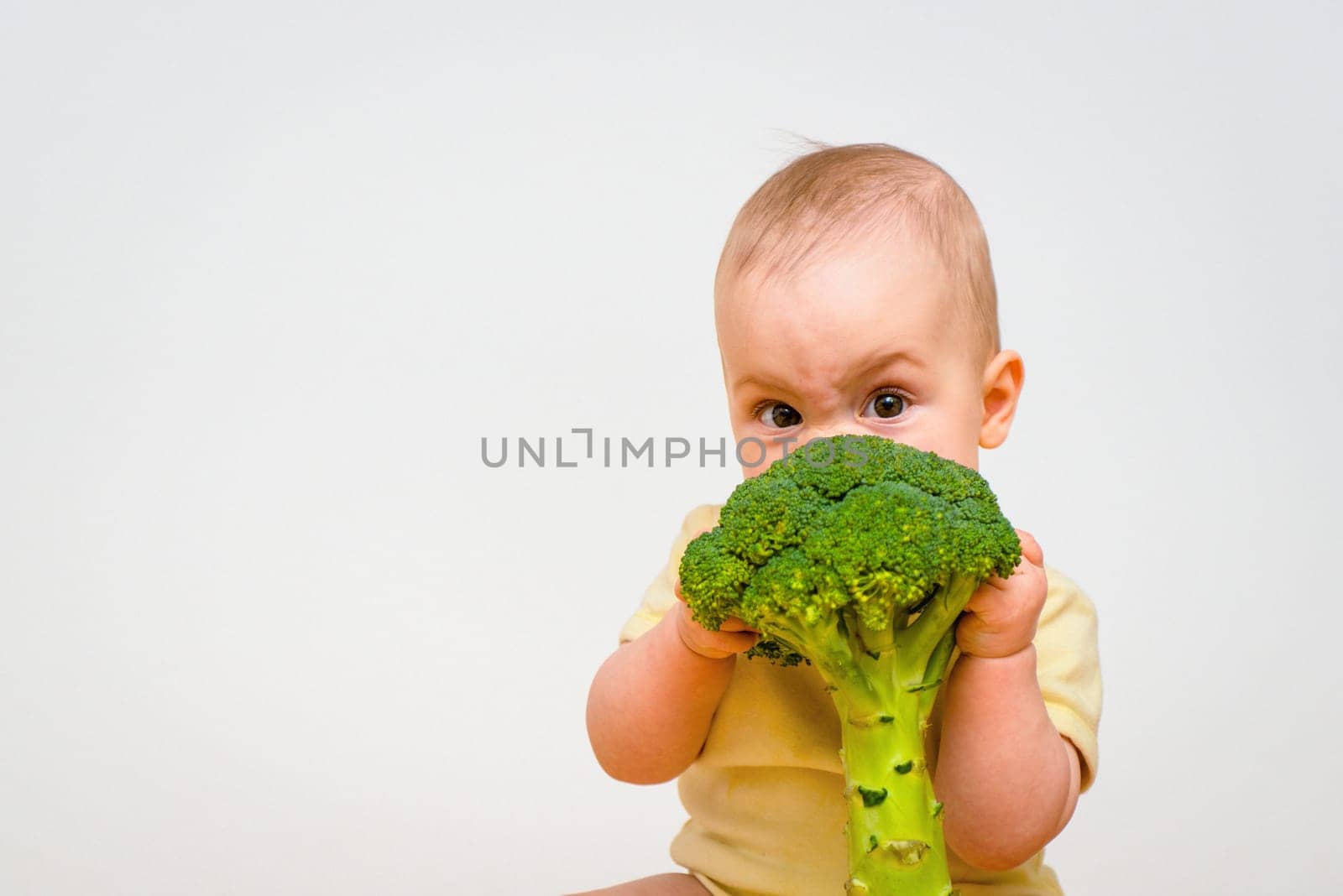 Cute baby eating broccoli - impact on eyes