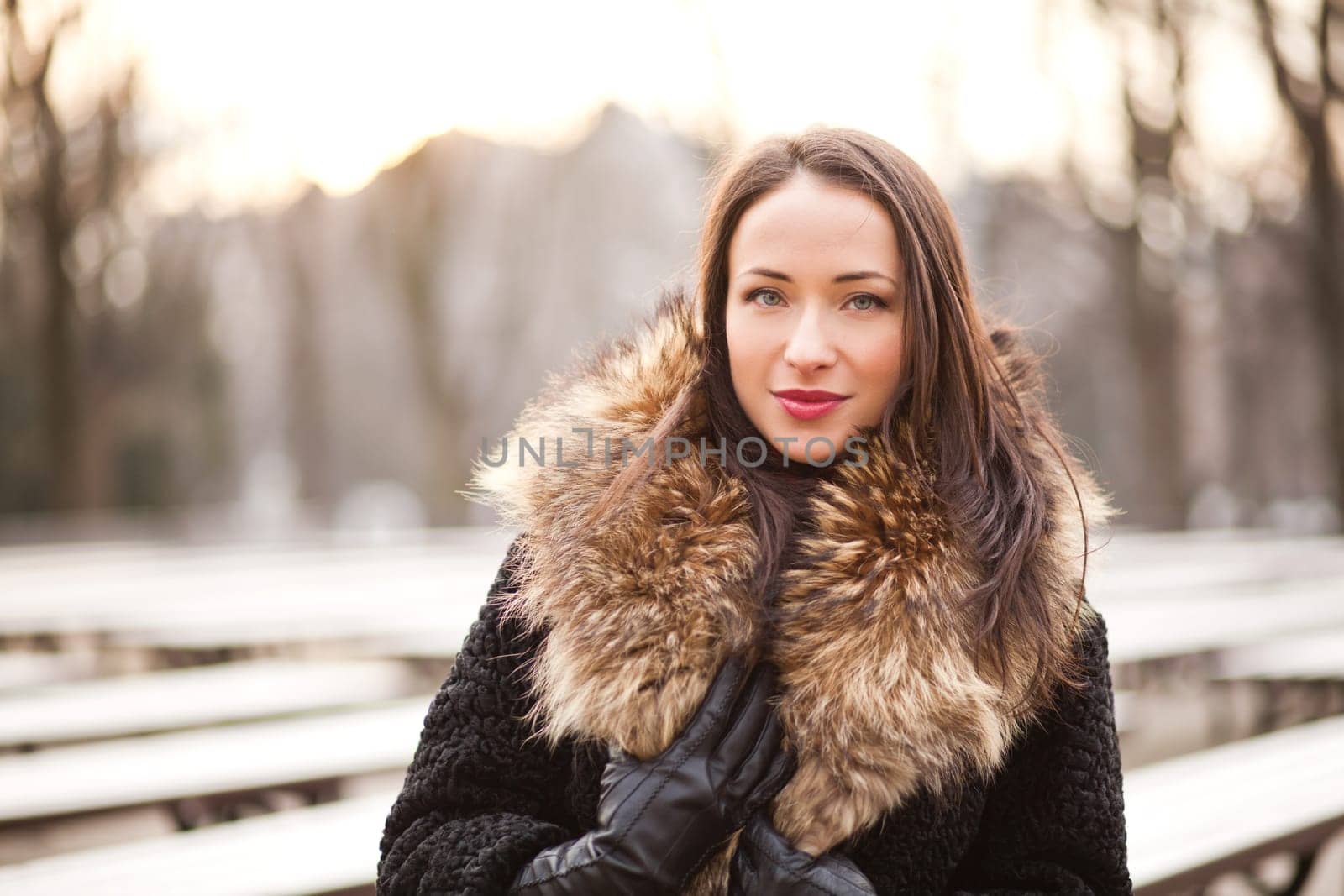 Beautiful lady is walking in the park in autumn