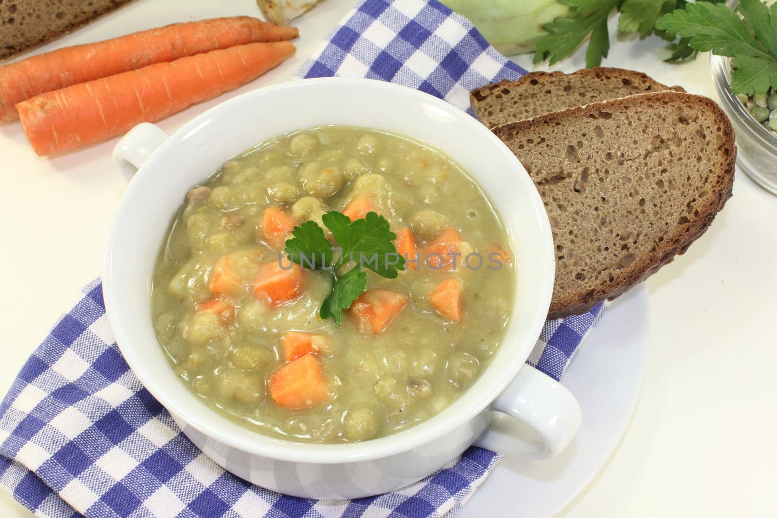 a white cup of pea stew and parsley