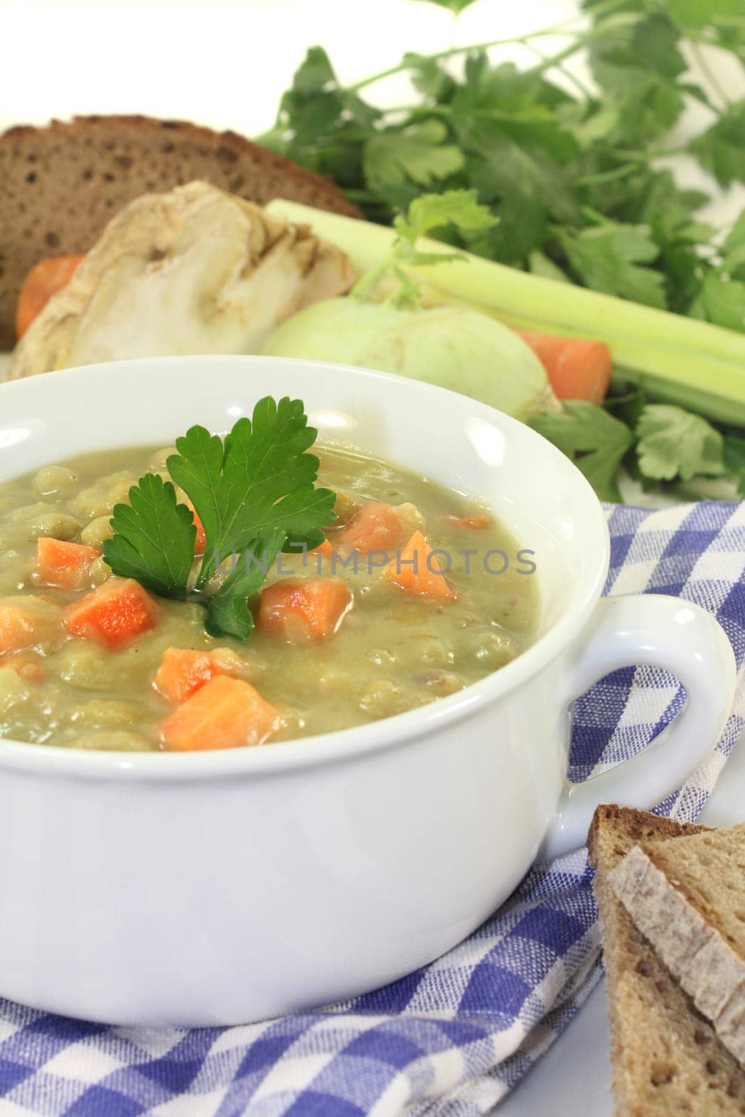 a white cup of pea stew and parsley