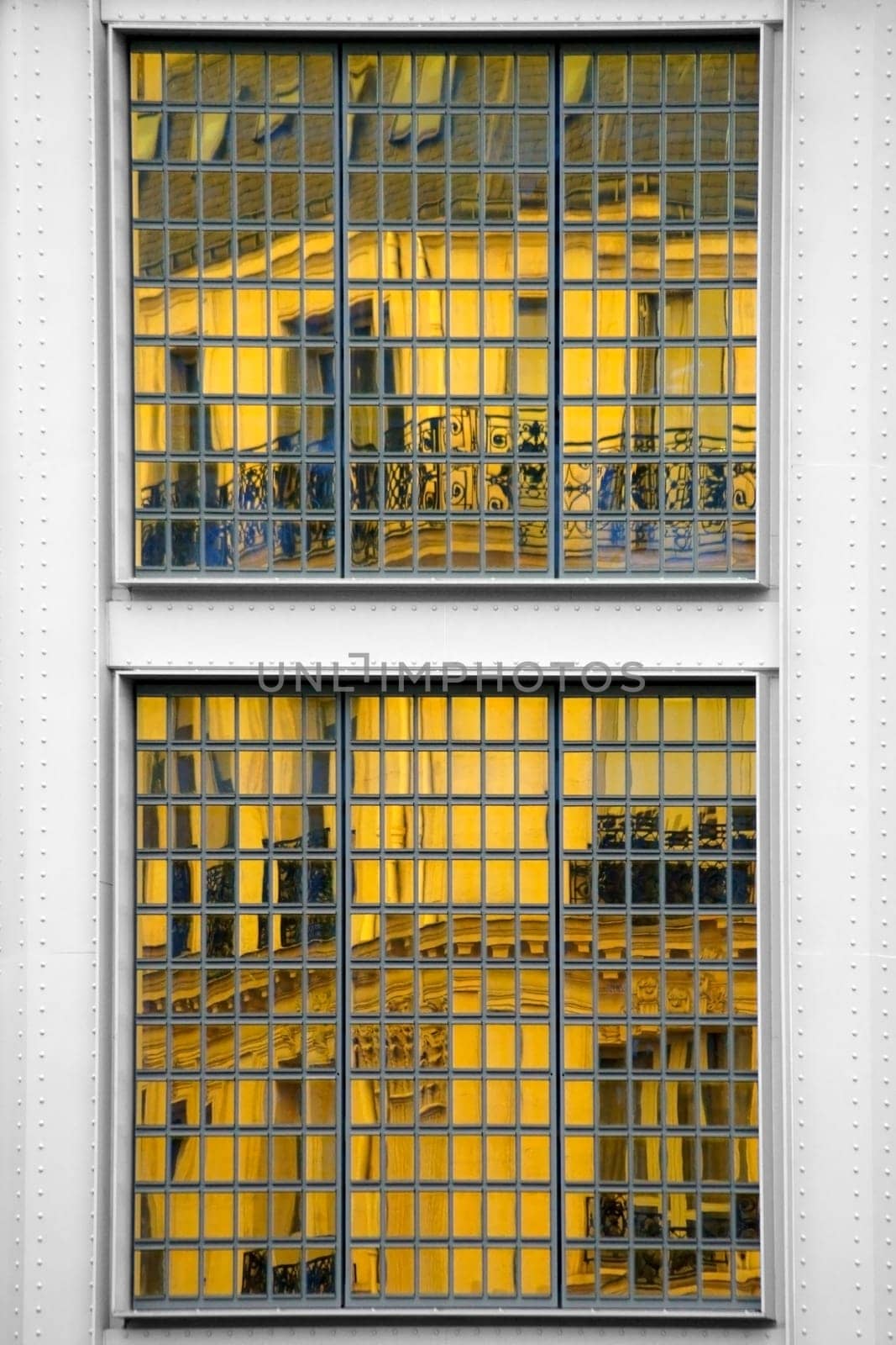 The photograph of a mirrored house in a façade with many small mirrors.