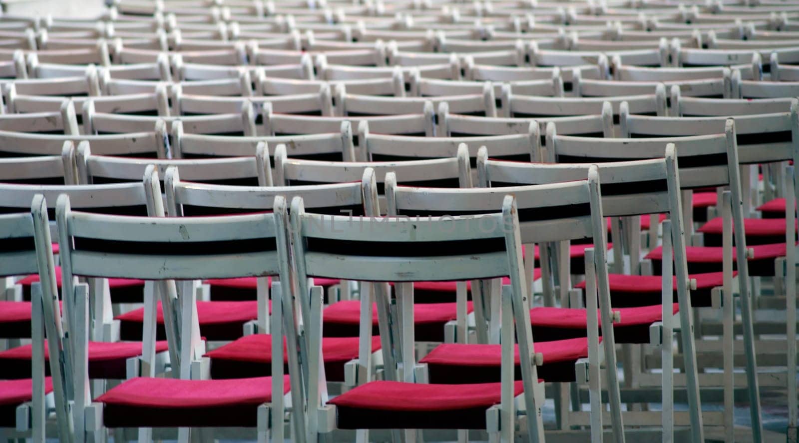 The photograph of chairs in rows of seats one behind the other.