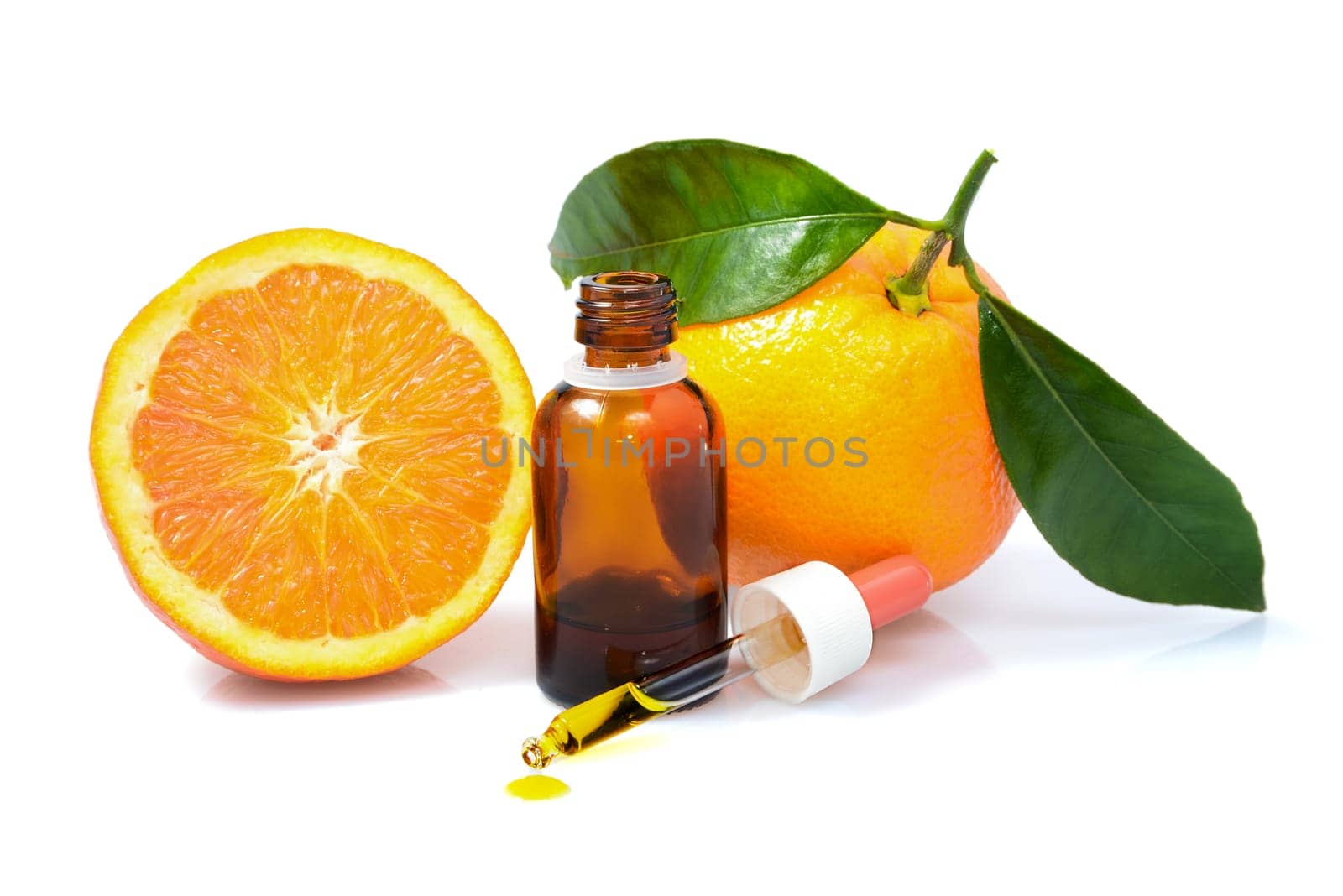 Orange with green leaves and a bottle with dropper isolated on a white background. Alternative medicine concept