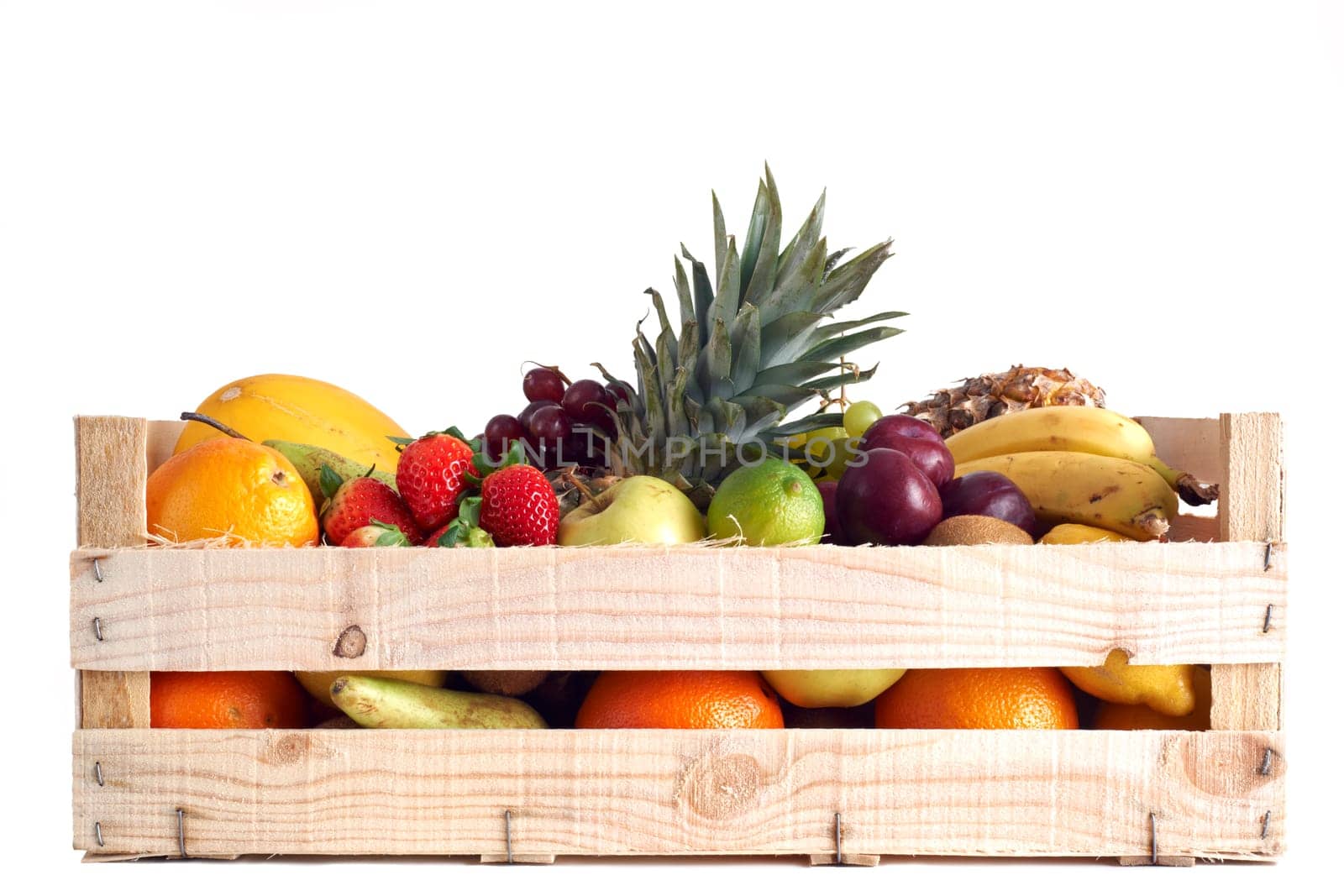 Various types of fruit stored in wooden box on white background
