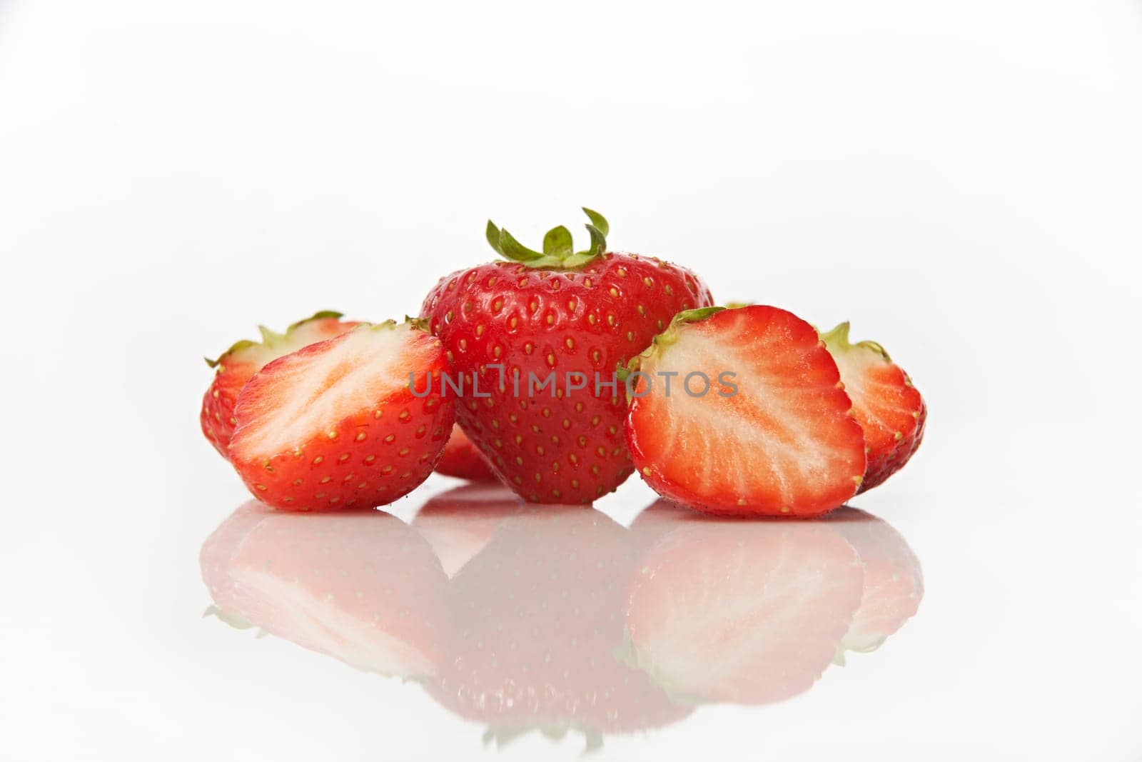 Studio shot of strawberries on white background with reflection