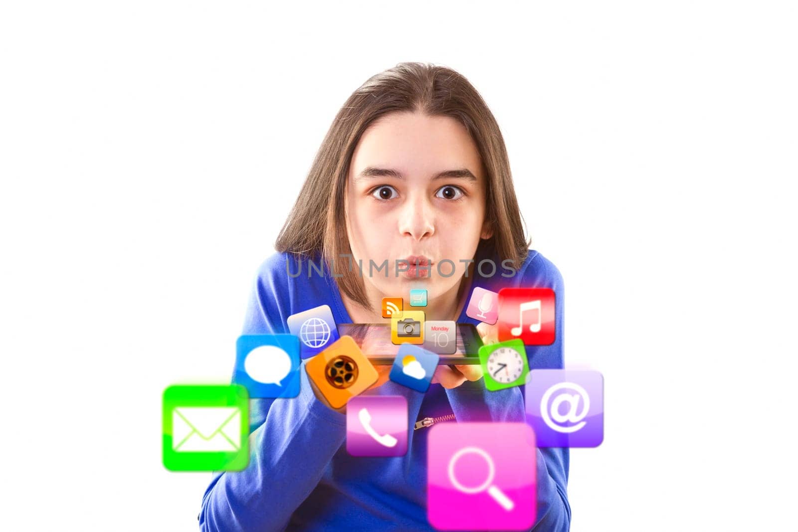 Teenage girl blowing app icons from digital tablet.