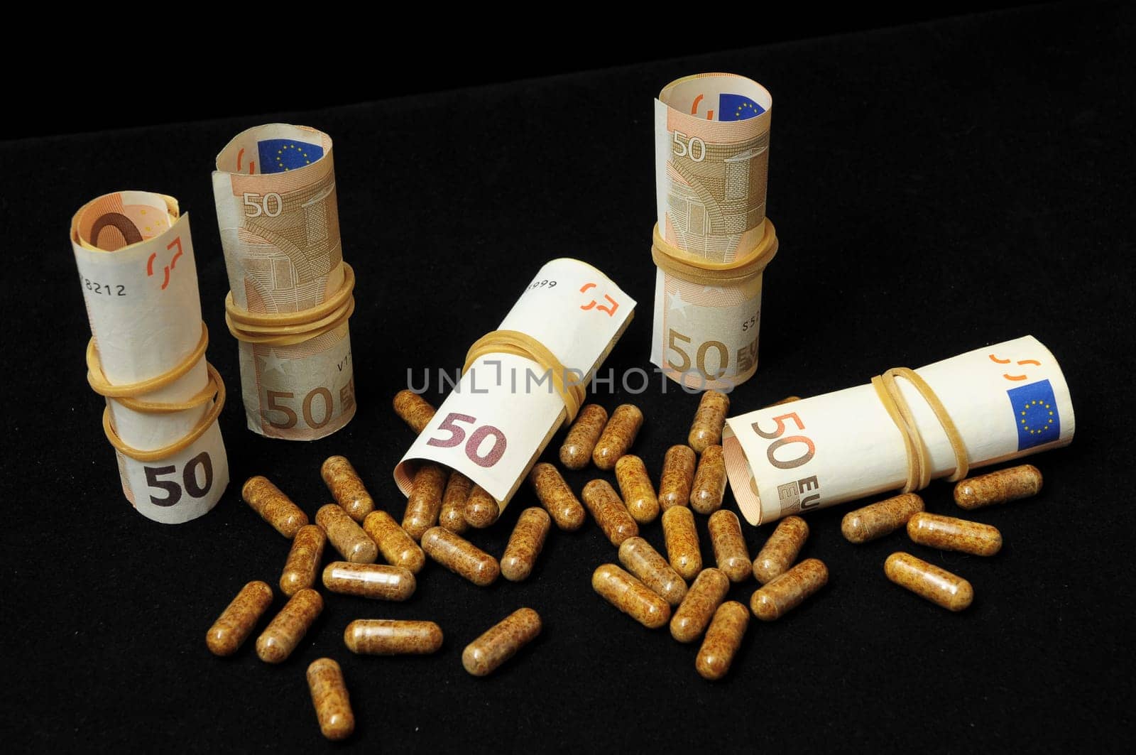 Some Pills And Money on a Black Background