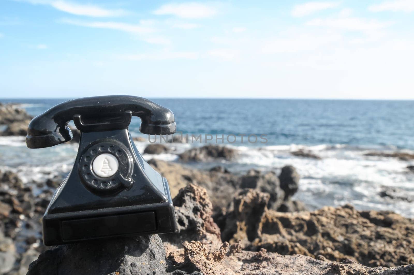 International Communications Vintage Telephone Toy on the Volcanic Rocks