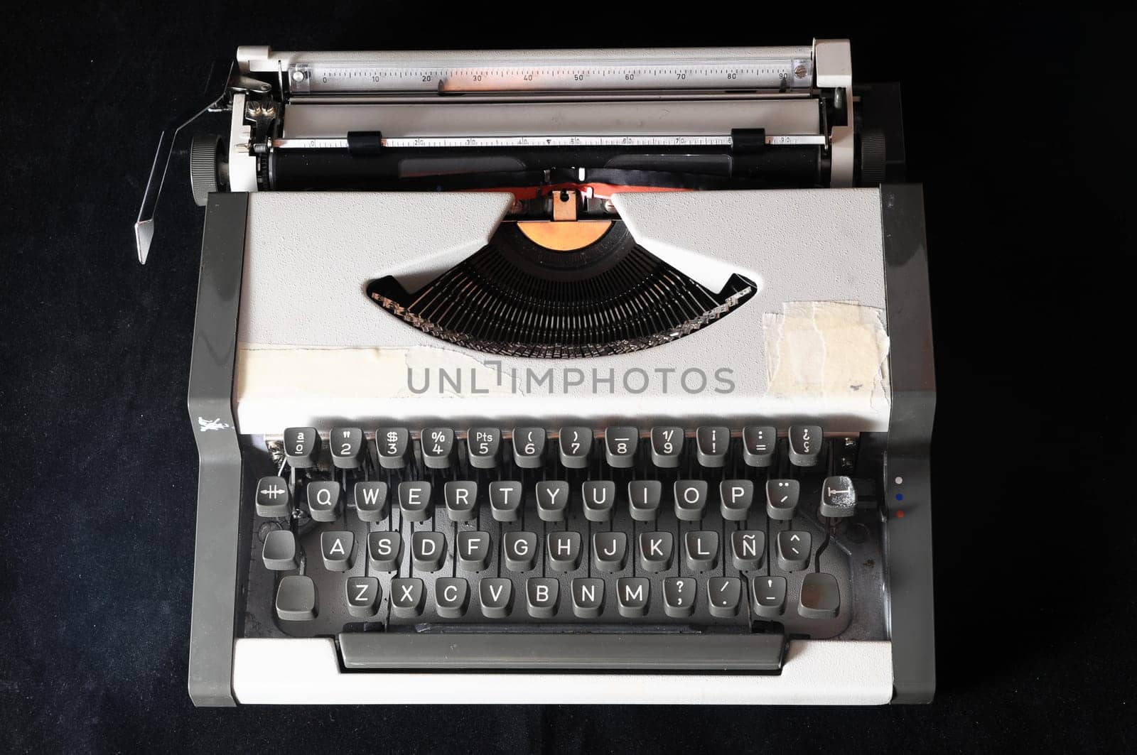 An Old Travel Vintage Typewriter on a Black Background