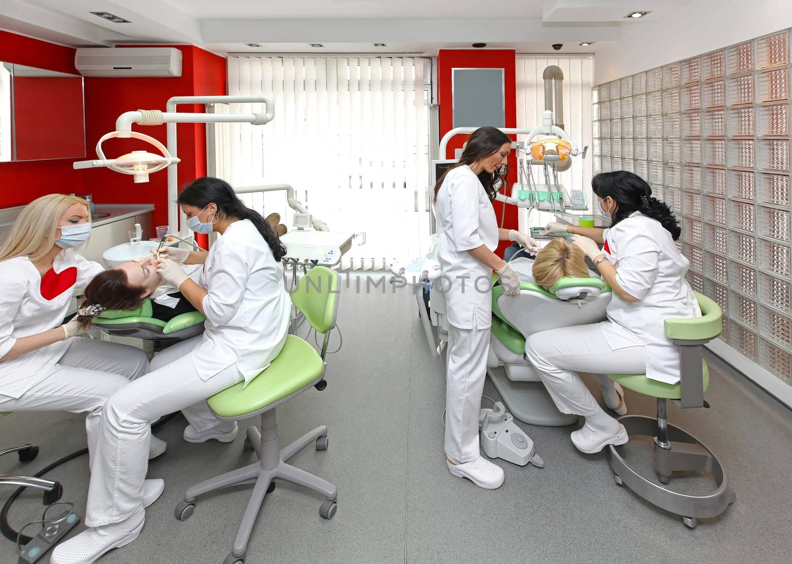 Dentists at work in modern dental office
