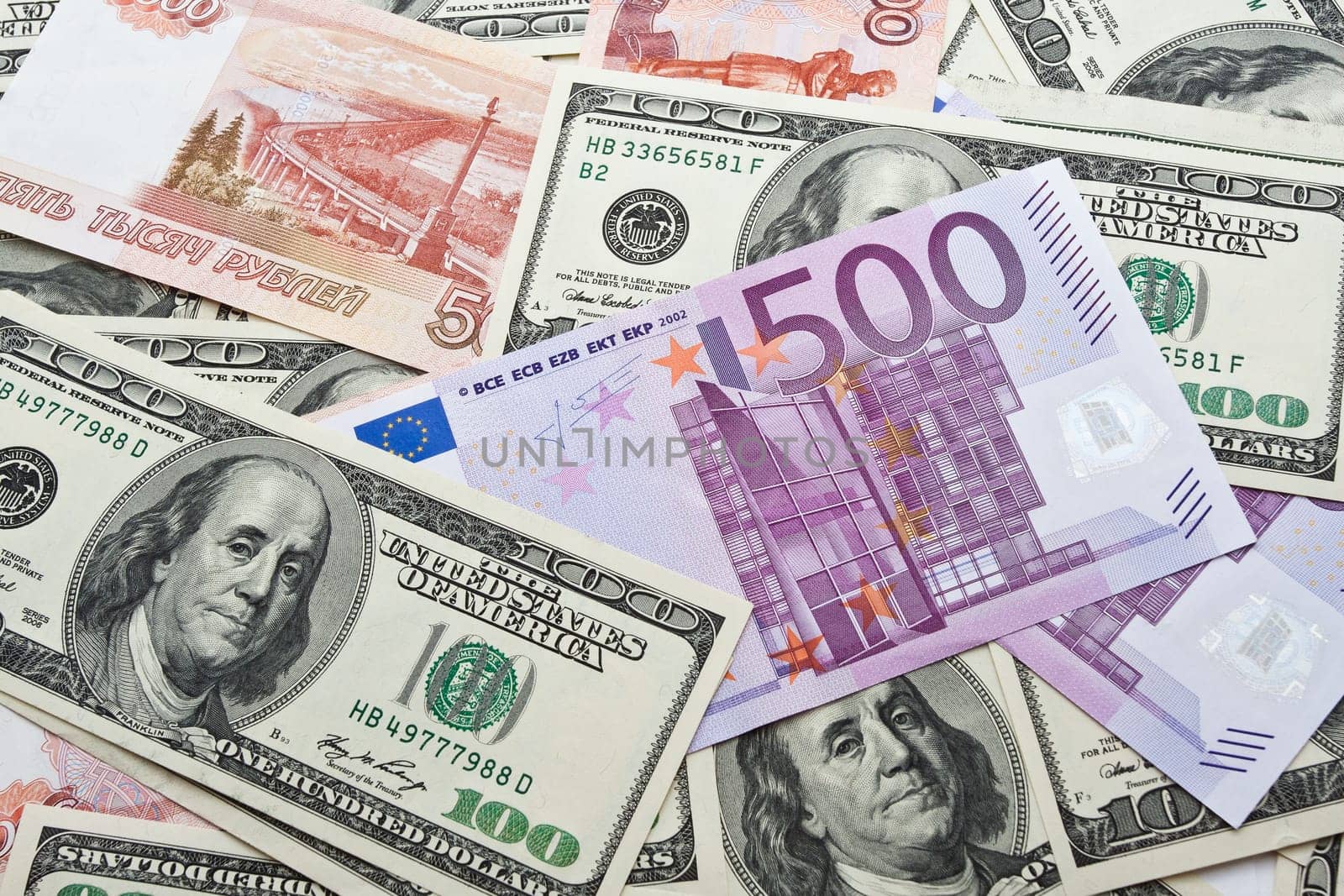 Lots of dollar and euro notes arranged in chaotic manner, background