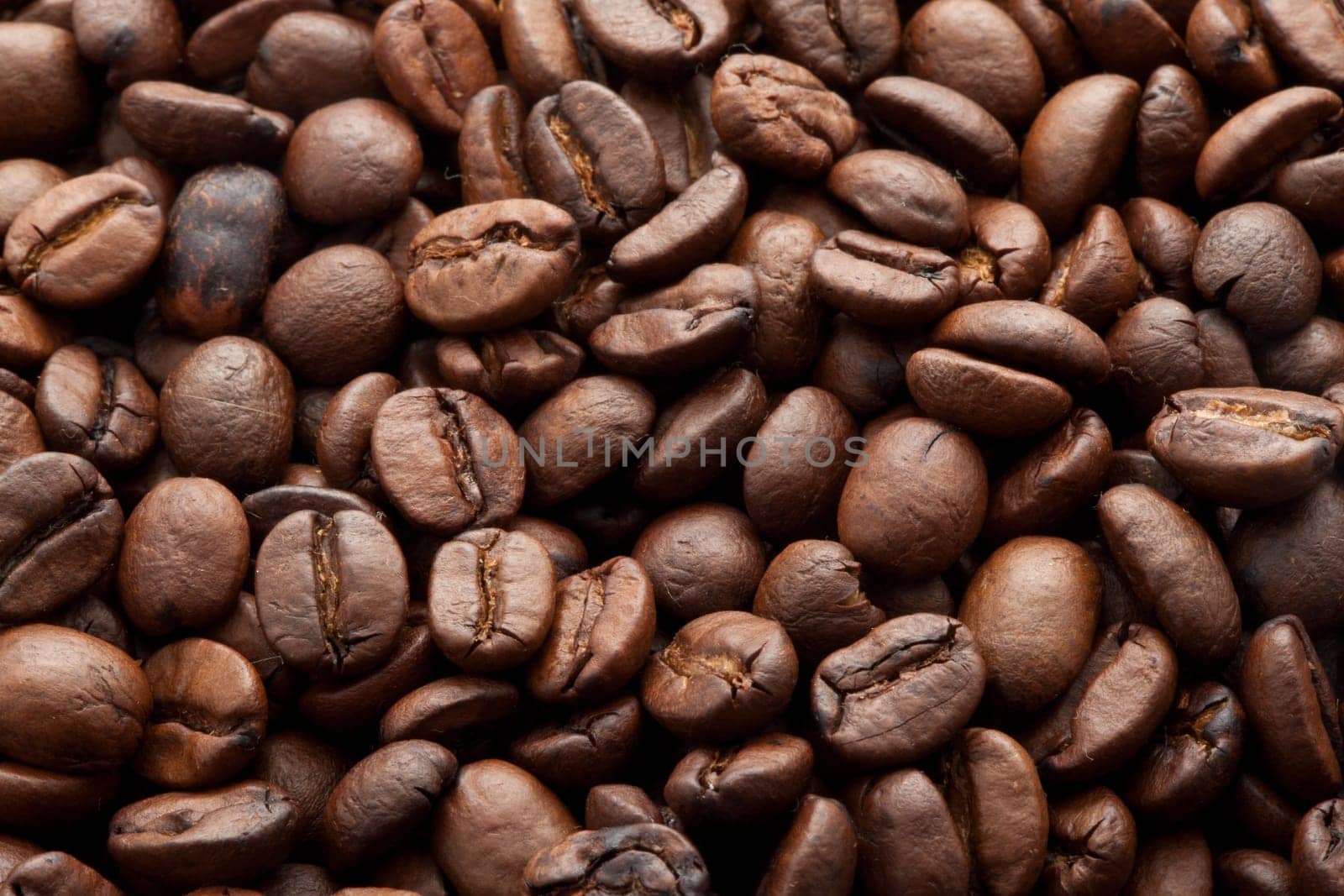 Close-up of brown coffee beans, background texture