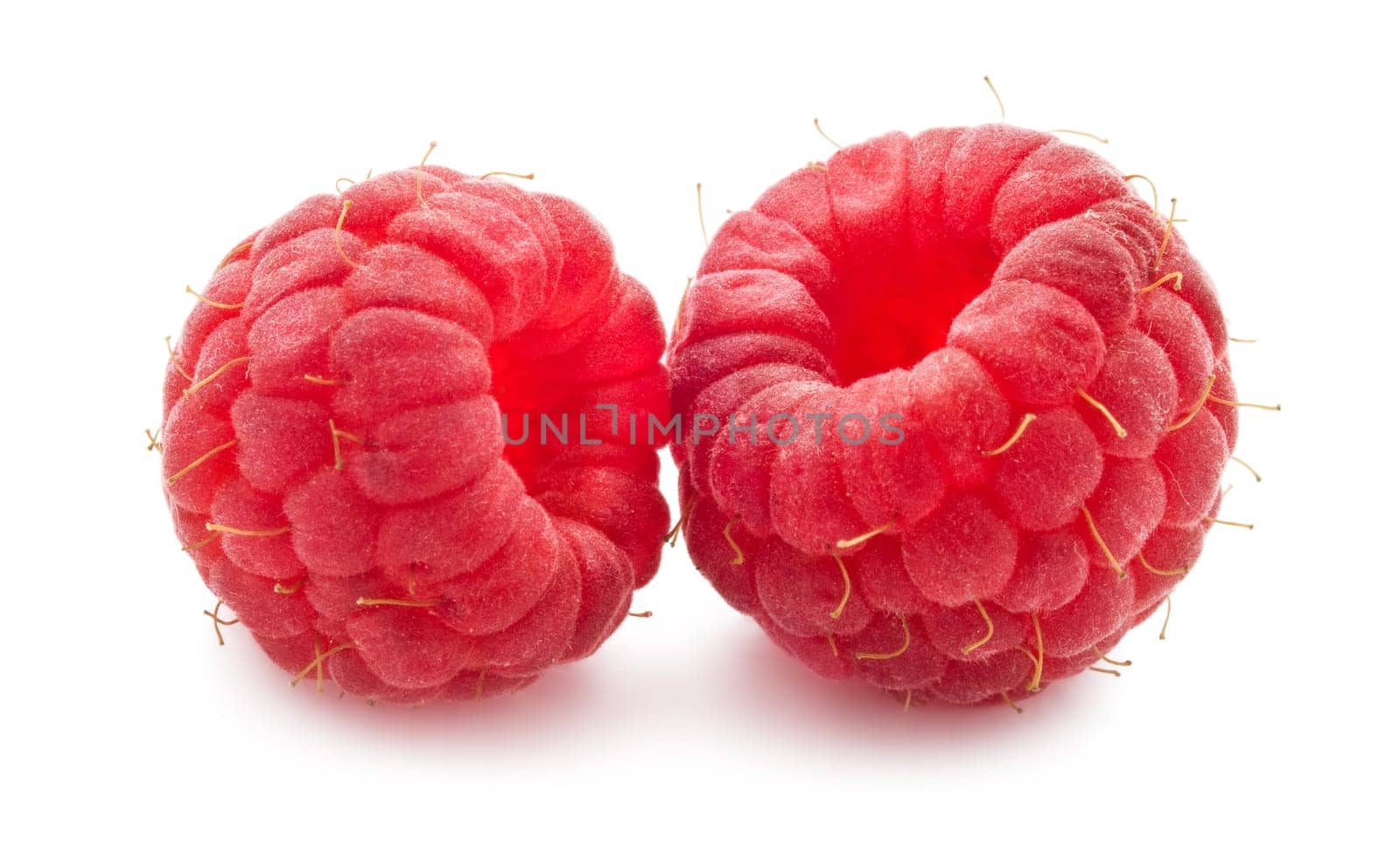 Ripe red raspberries isolated on white background