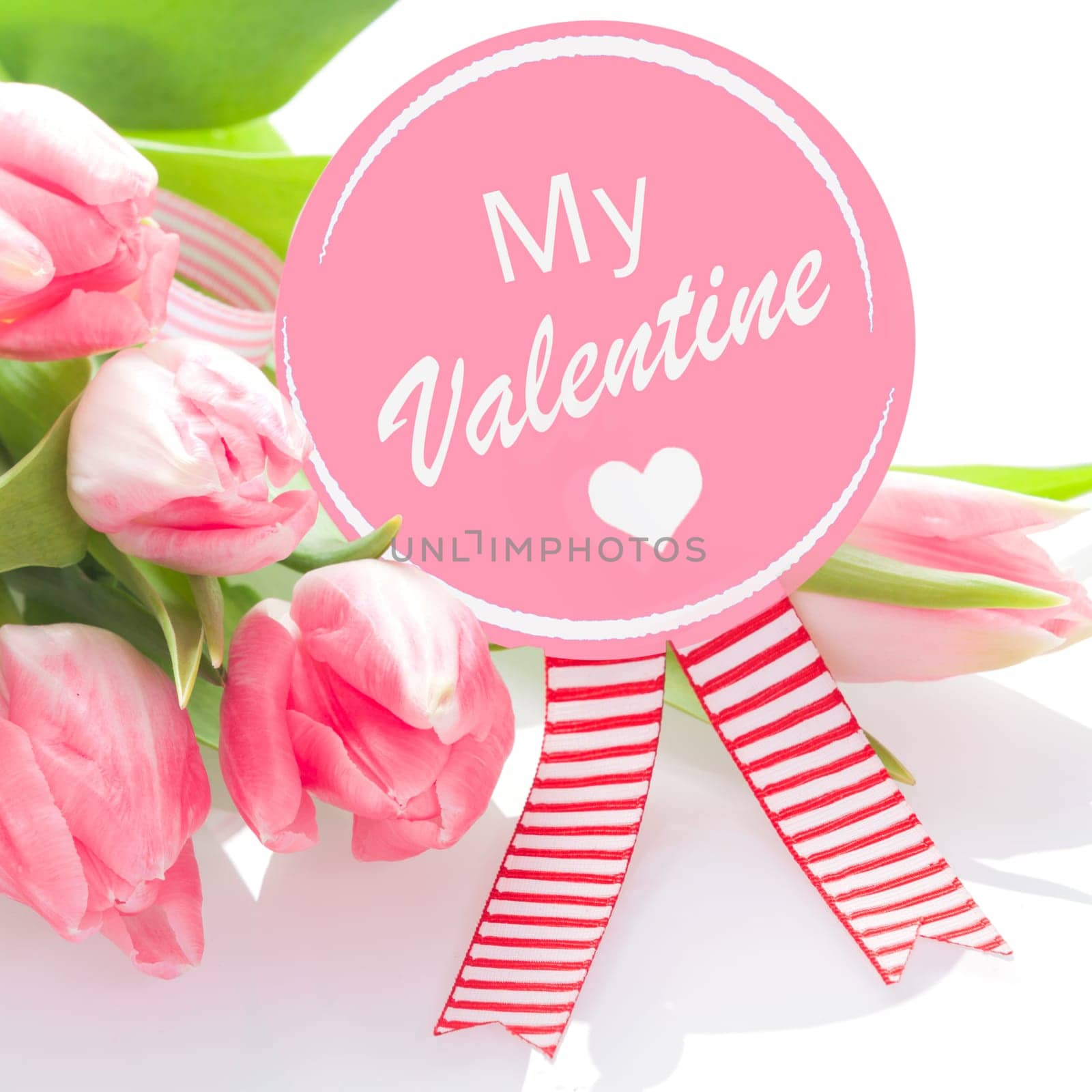 My Valentines greeting rosette with a romantic heart and a bouquet of fresh pink tulips for a loving gift on Valentines Day