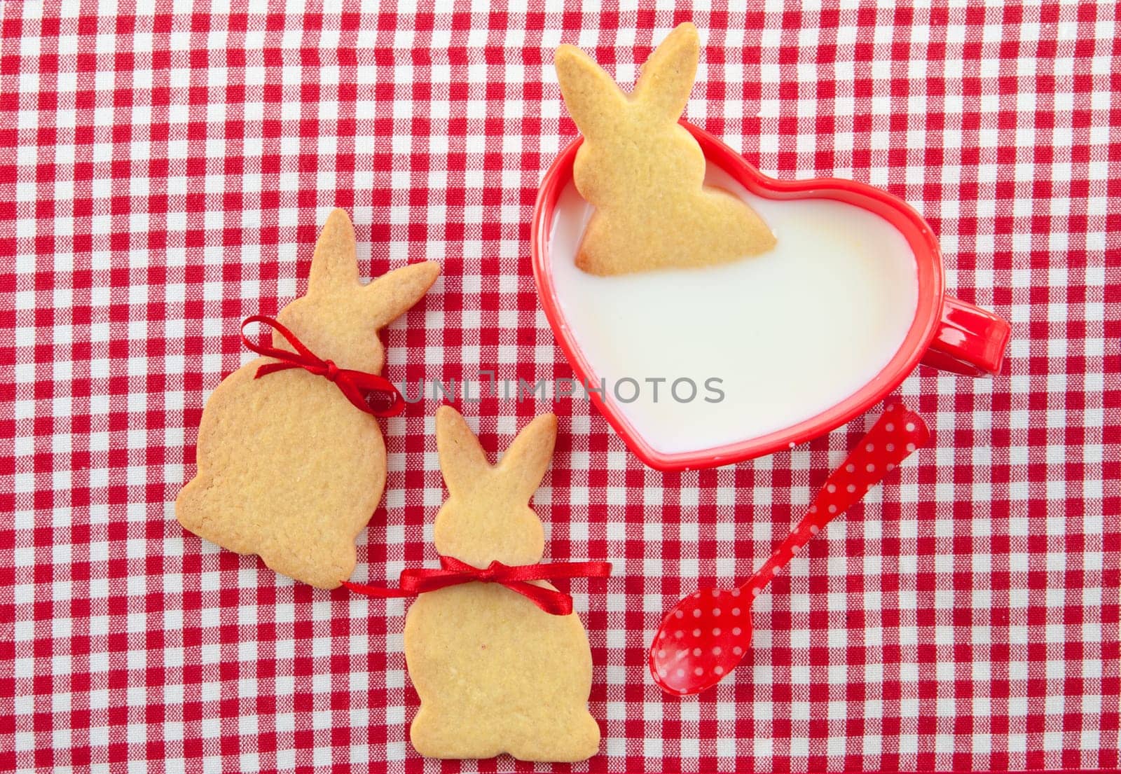 Milk and biscuits in the shape of Easter bunnies