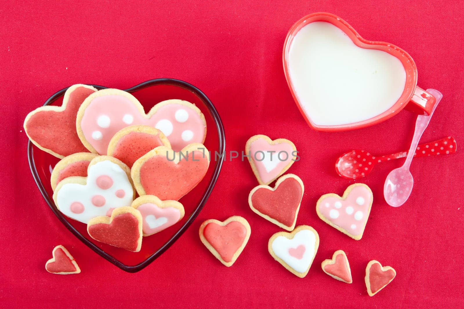 Heart-shaped colorful biscuits and a cup of milk