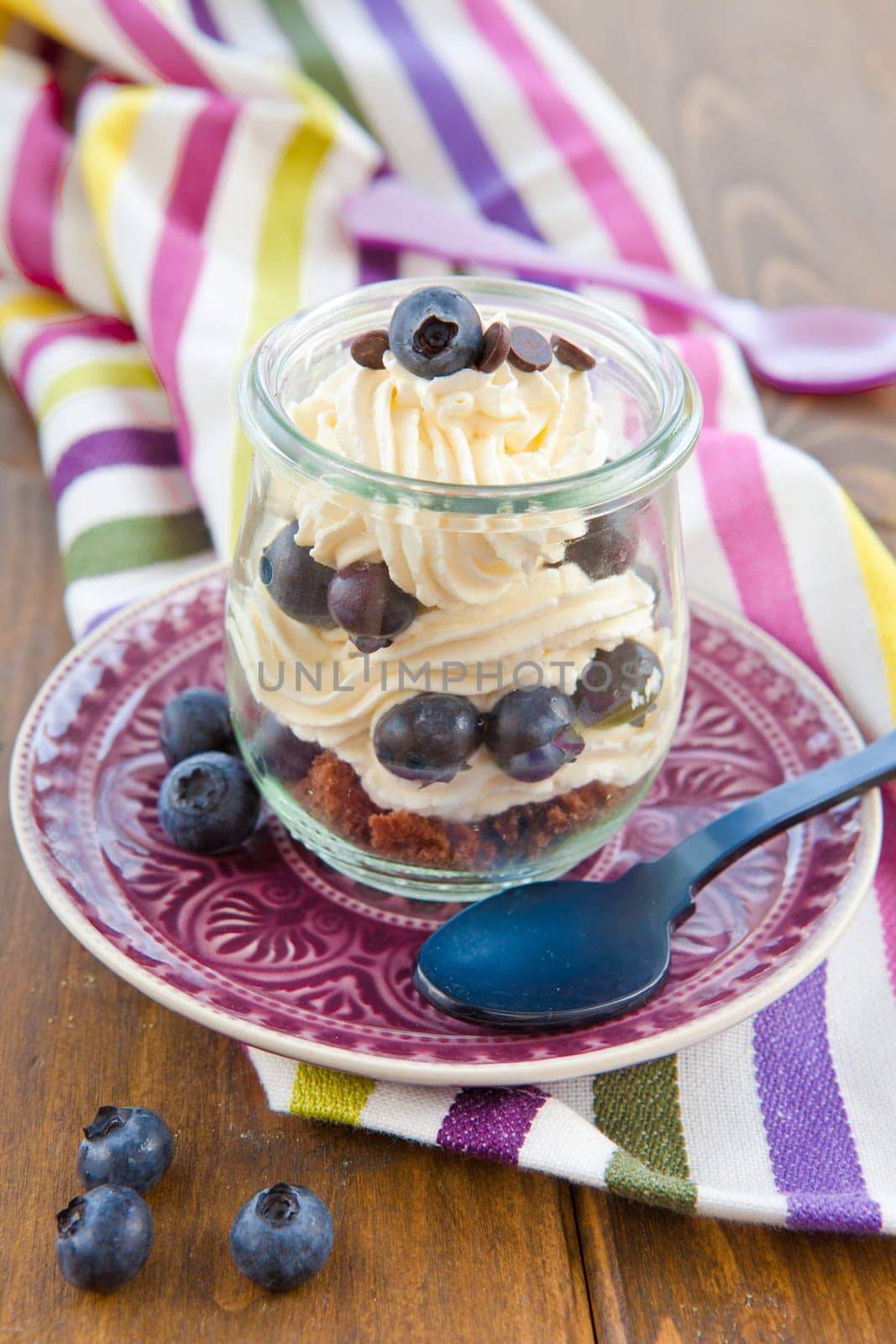 Creamy dessert in layers with fresh blueberries