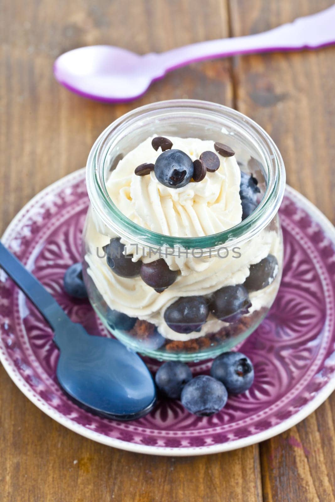Creamy dessert in layers with fresh blueberries