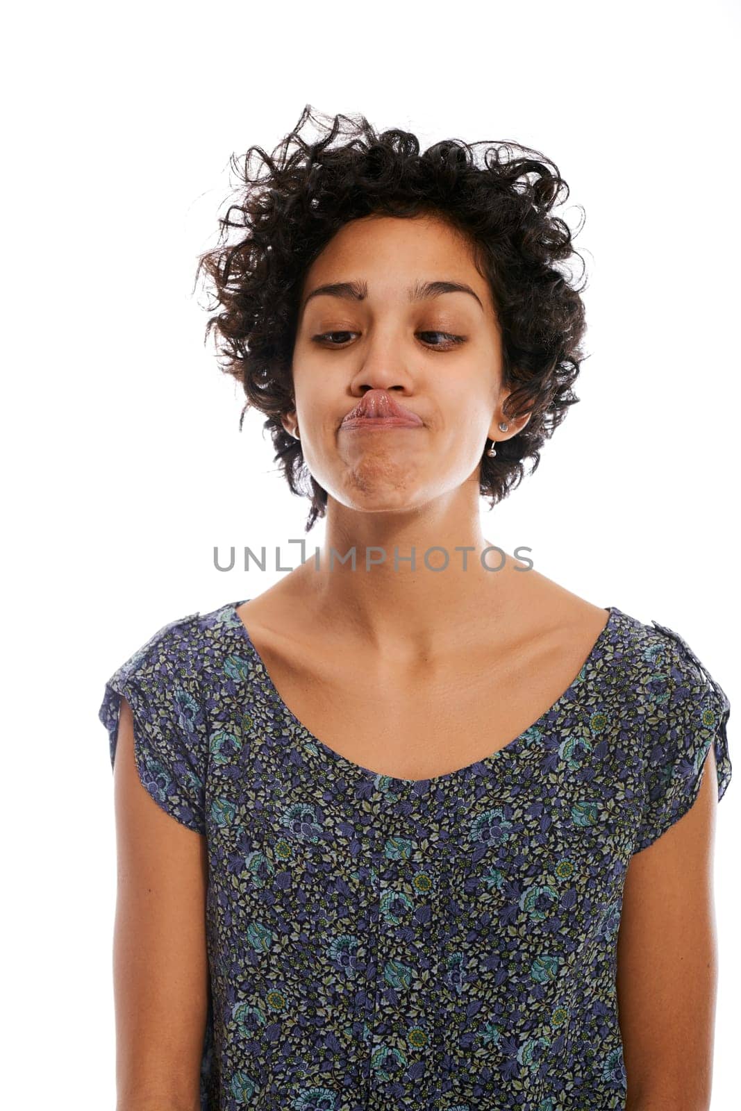 hispanic woman doing facial expression and touching nose with tongue on white background