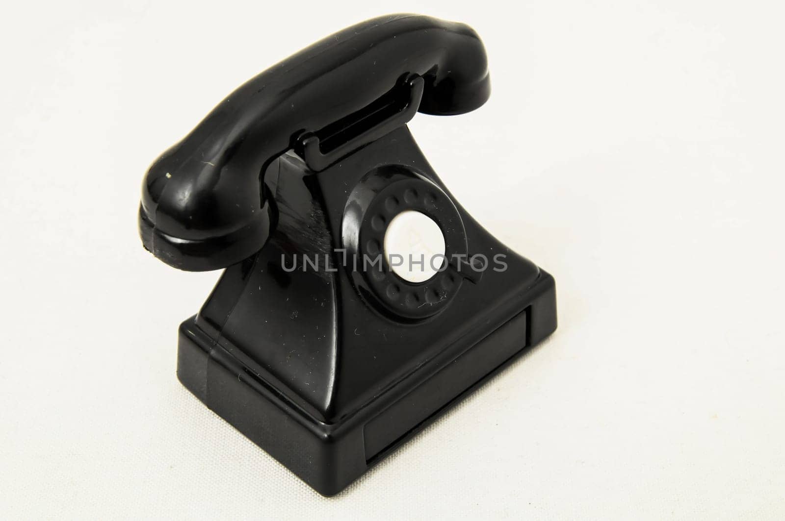 Vintage Old Telephone Plastic Black Toy on a White Background