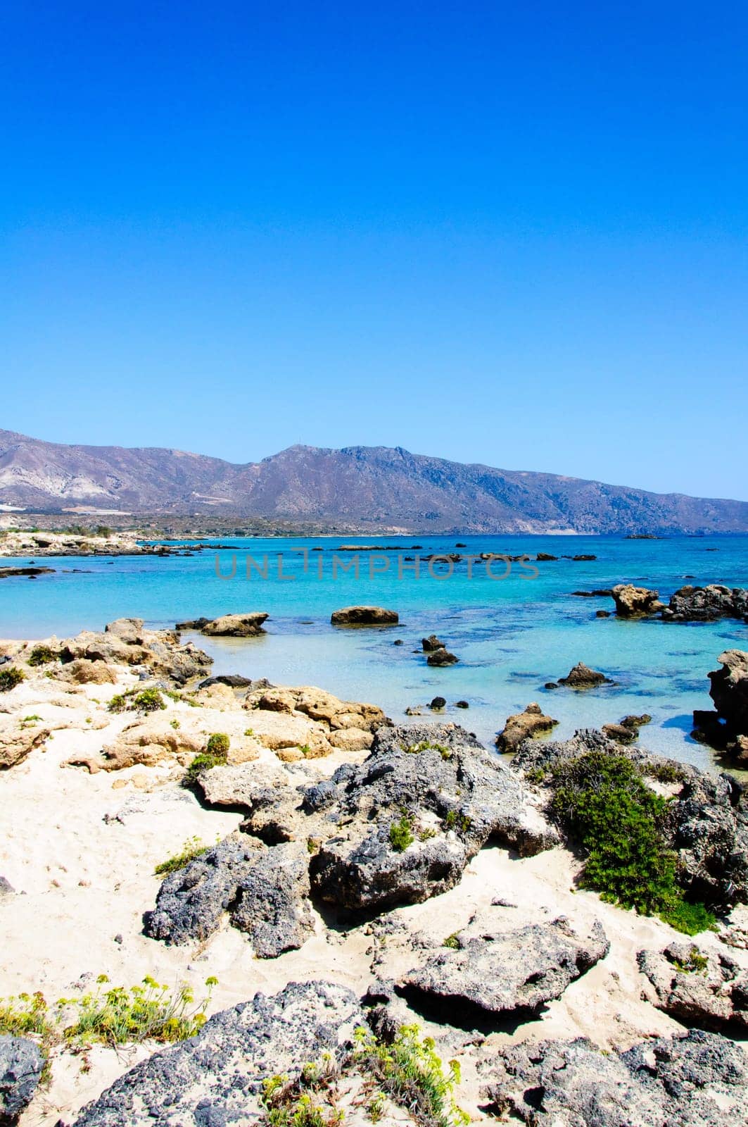 Elafonisi or Elafonissi, "deer island"" in Greek, is an island located close to the southwestern corner of the Mediterranean island of Crete, Greece. Elafonisi is an oblong, which often ""breaks"" in two parts by water giving the impression of being a separate island. The island is a protected nature reserve."