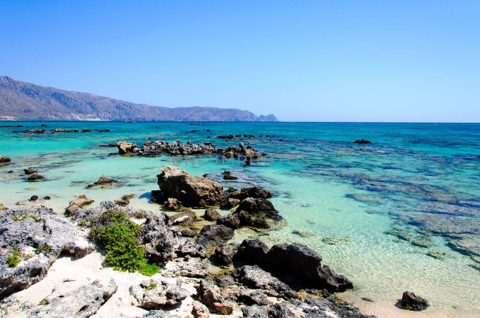 Elafonisi or Elafonissi, "deer island"" in Greek, is an island located close to the southwestern corner of the Mediterranean island of Crete, Greece. Elafonisi is an oblong, which often ""breaks"" in two parts by water giving the impression of being a separate island. The island is a protected nature reserve."