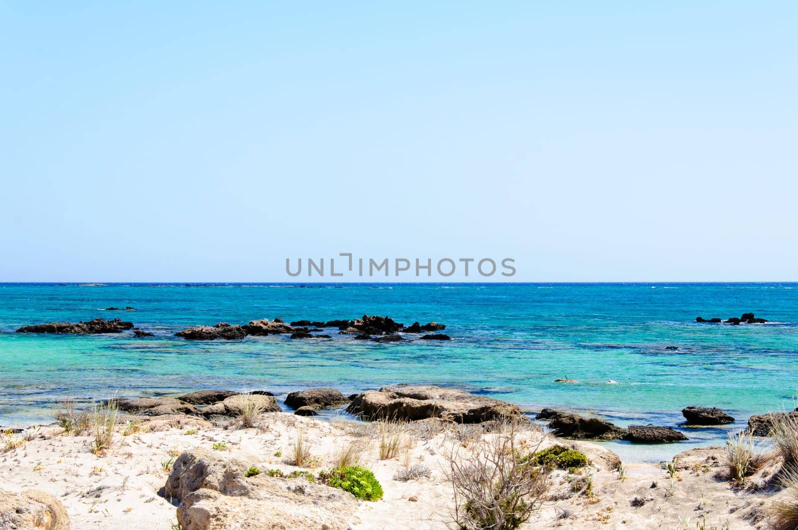 Elafonisi or Elafonissi, "deer island"" in Greek, is an island located close to the southwestern corner of the Mediterranean island of Crete, Greece. Elafonisi is an oblong, which often ""breaks"" in two parts by water giving the impression of being a separate island. The island is a protected nature reserve."