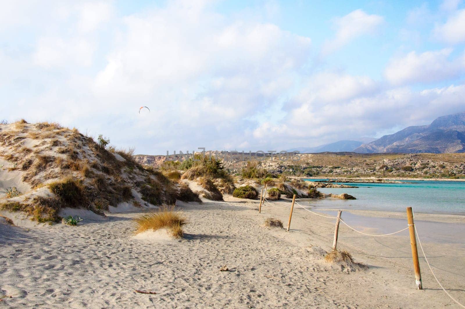 Elafonisi or Elafonissi, "deer island"" in Greek, is an island located close to the southwestern corner of the Mediterranean island of Crete, Greece. Elafonisi is an oblong, which often ""breaks"" in two parts by water giving the impression of being a separate island. The island is a protected nature reserve."