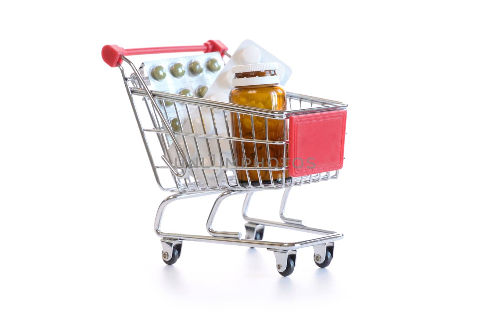 Shopping cart with pills and medicine isolated on white
