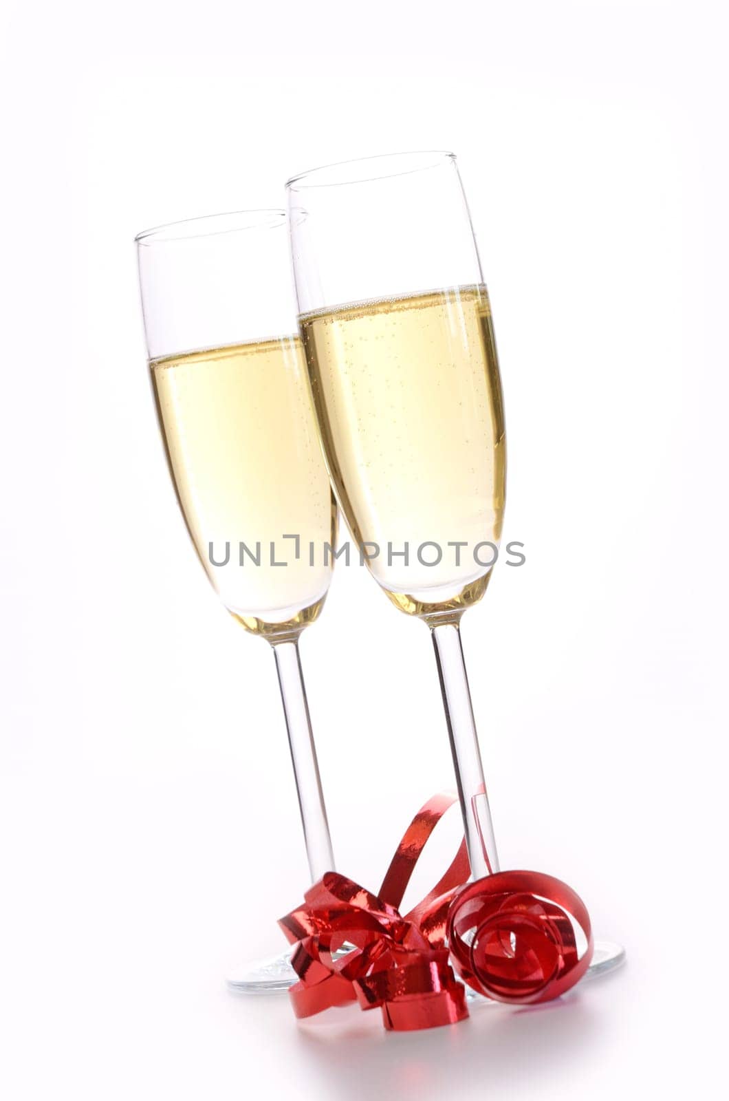 Two glasses of sparkling wine with a red bow
