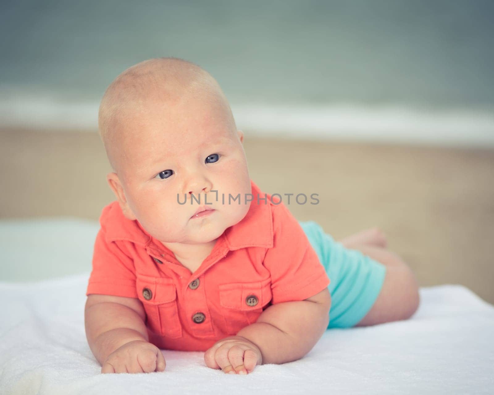 Cute baby laying on the sunbed at the beach