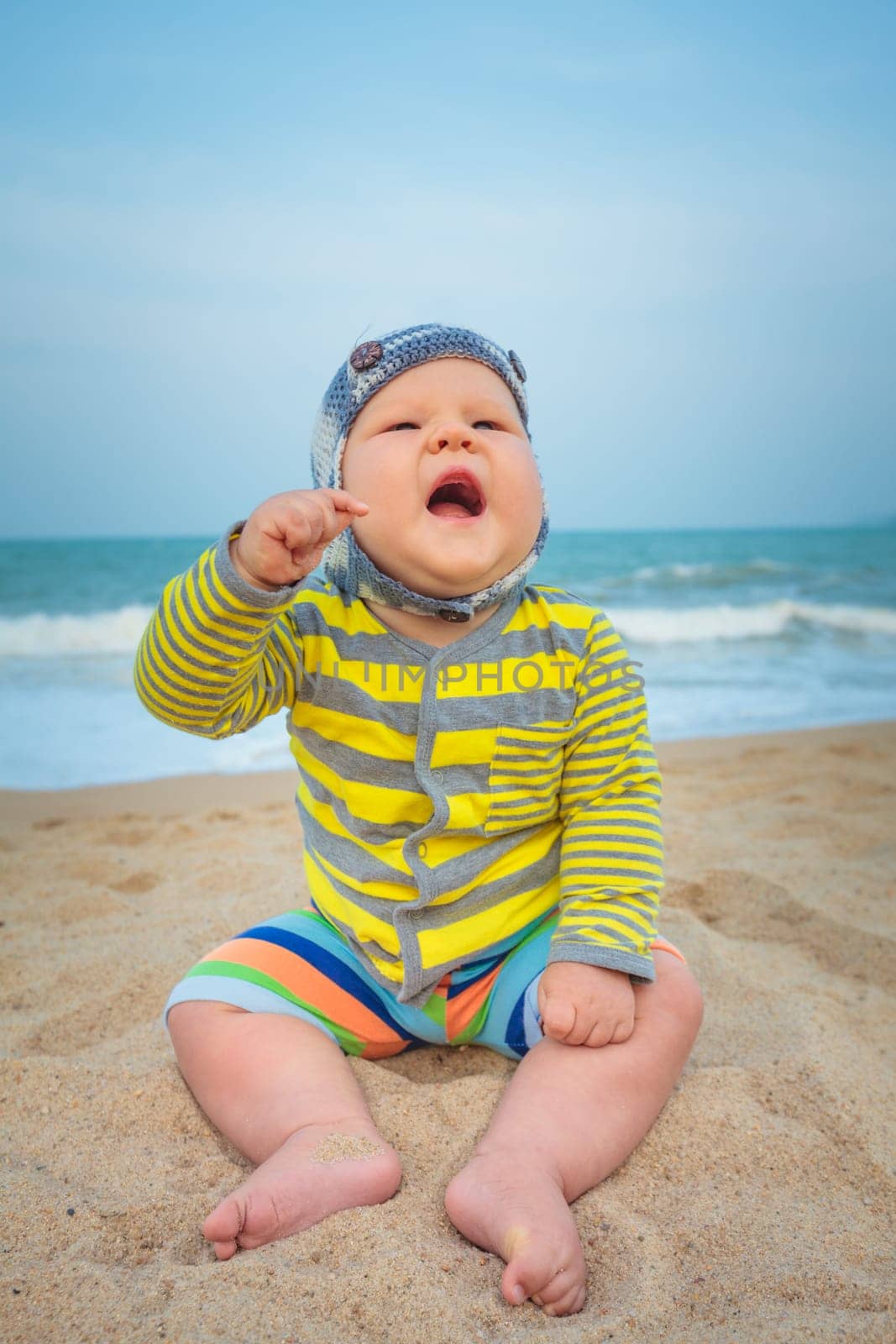 Cute baby sitting on a sand