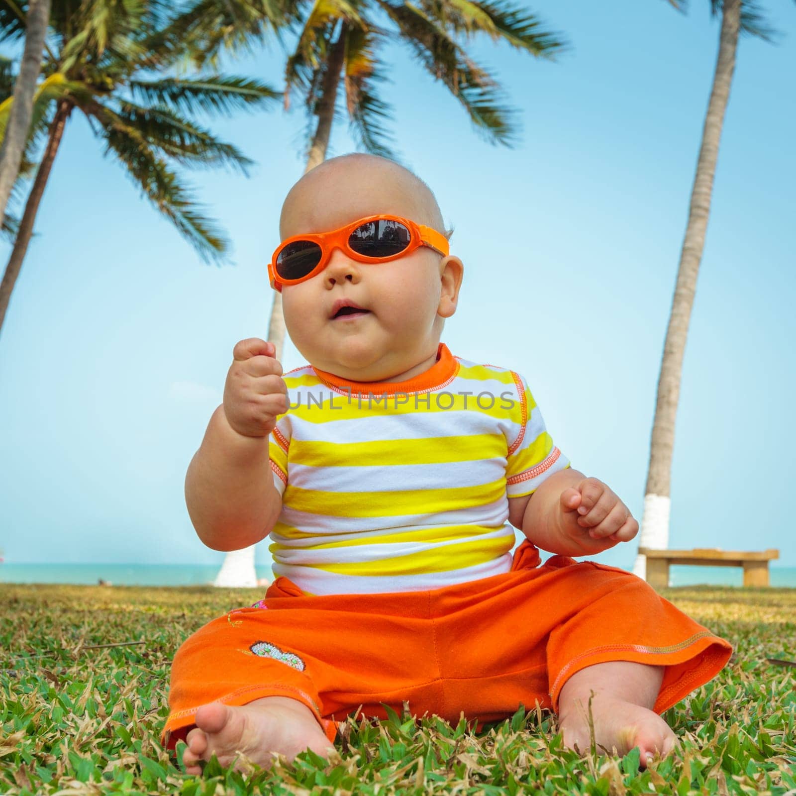 Cute baby sitting on a grass