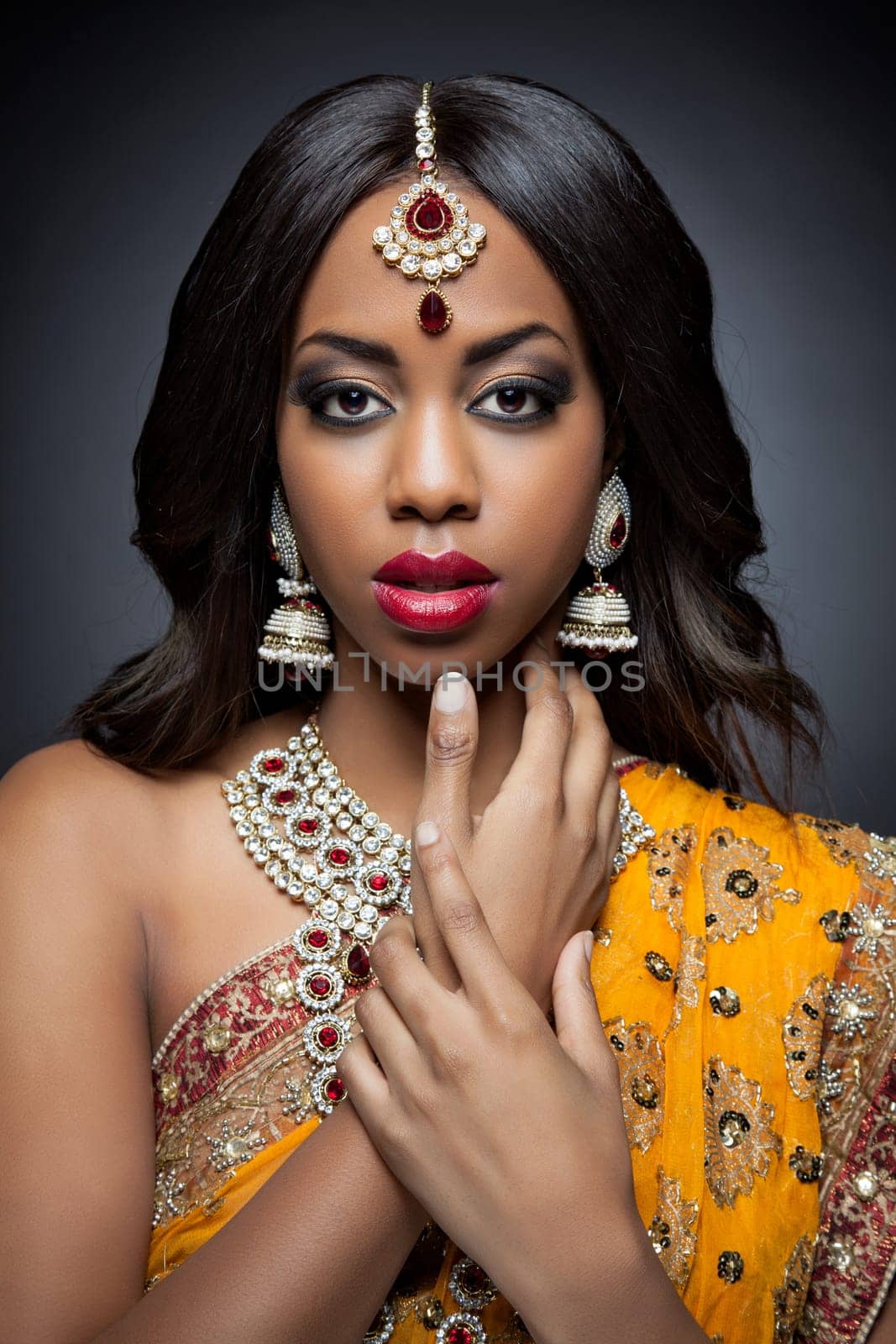 Young Indian woman dressed in traditional clothing with bridal makeup and jewelry
