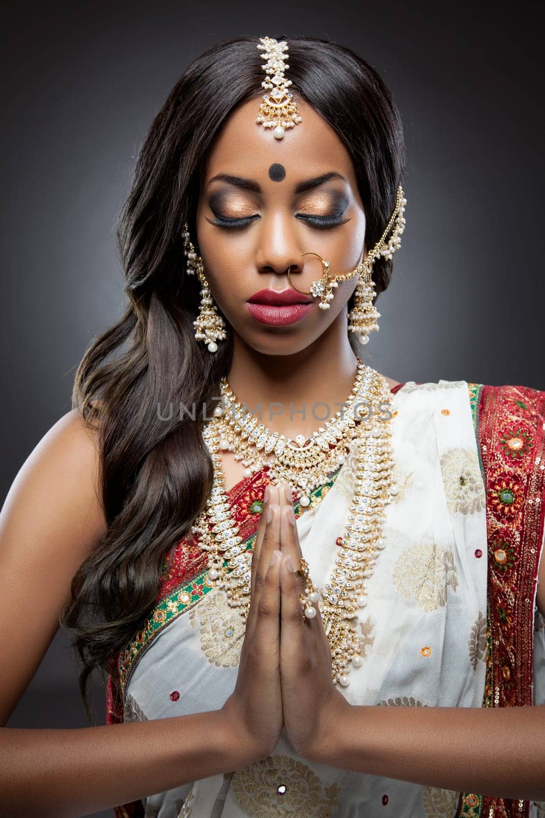 Young Indian woman dressed in traditional clothing with bridal makeup and jewelry