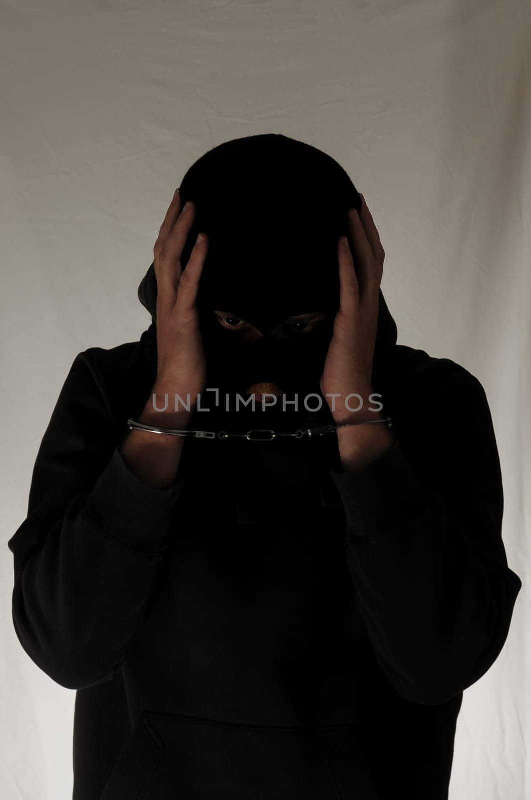 Black Dressed Young Man Trapped in Hancduffs